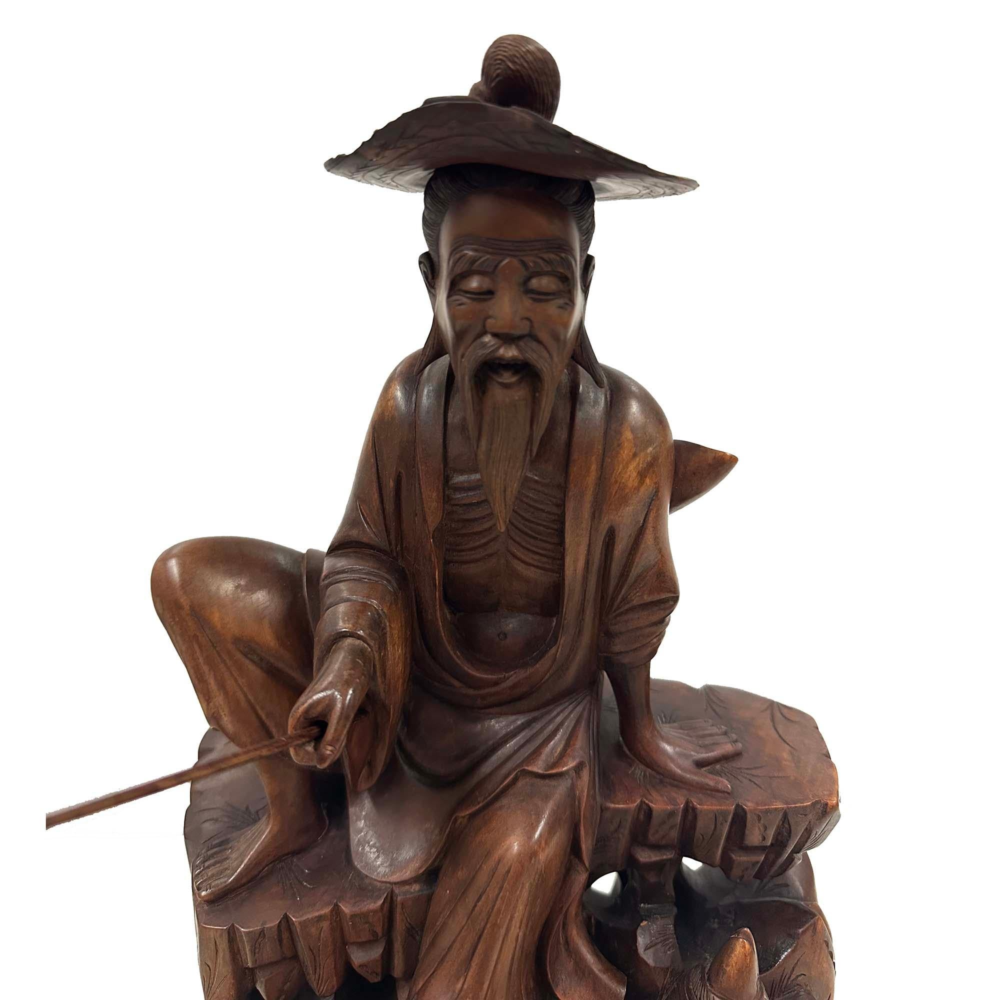 This is a Chinese hand-carved wooden statue, depicting the legendary figure Jiang Ziya (also known as Jiang Taigong), a famous general and strategist from ancient China. 
In Chinese folklore, Jiang Ziya is known for his wisdom and patience. He is