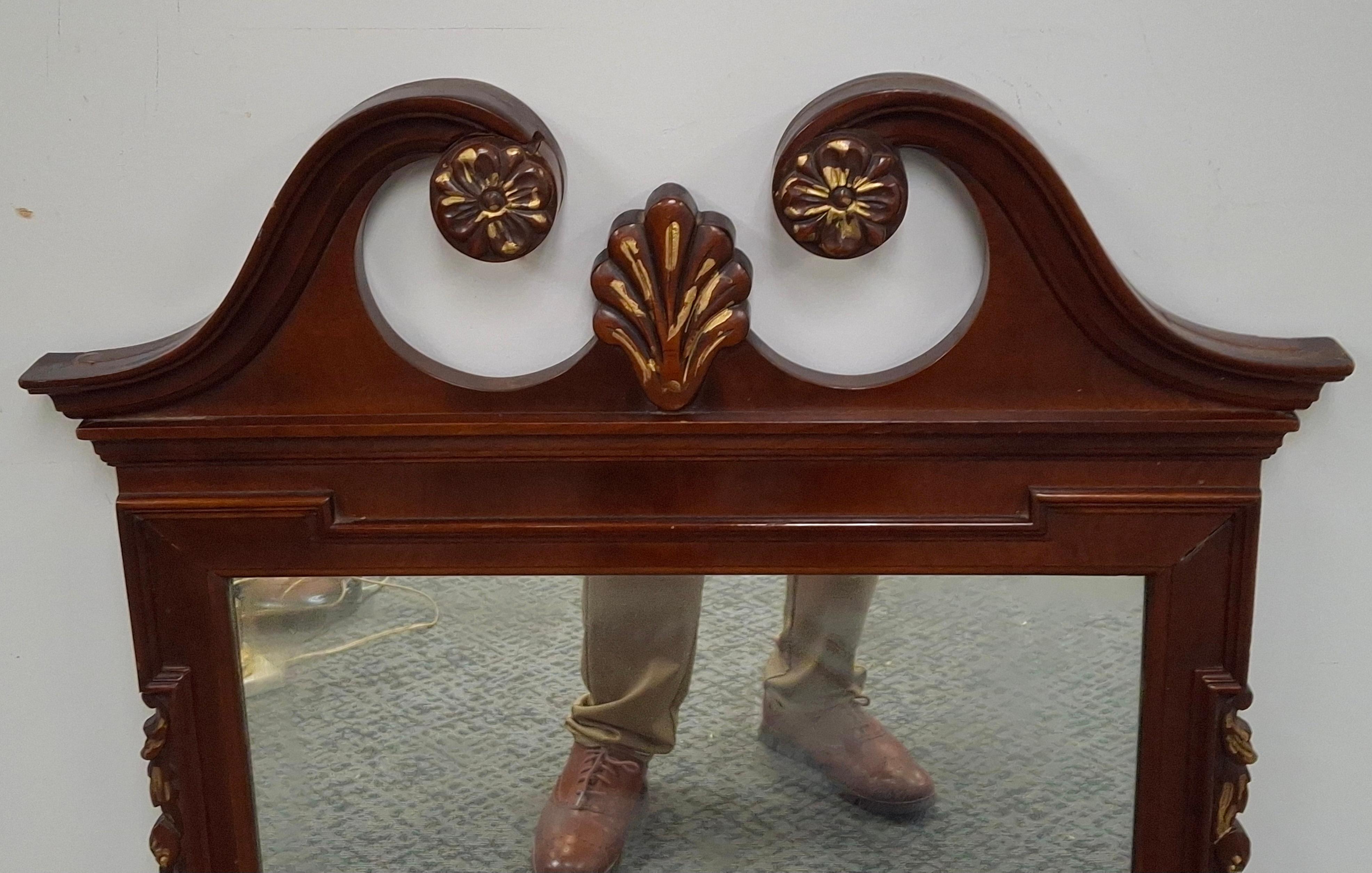 A Mid-20th Century Chippendale Style Mahogany Parcel Gilt Scroll Ear Wall Mirror
Measures 26