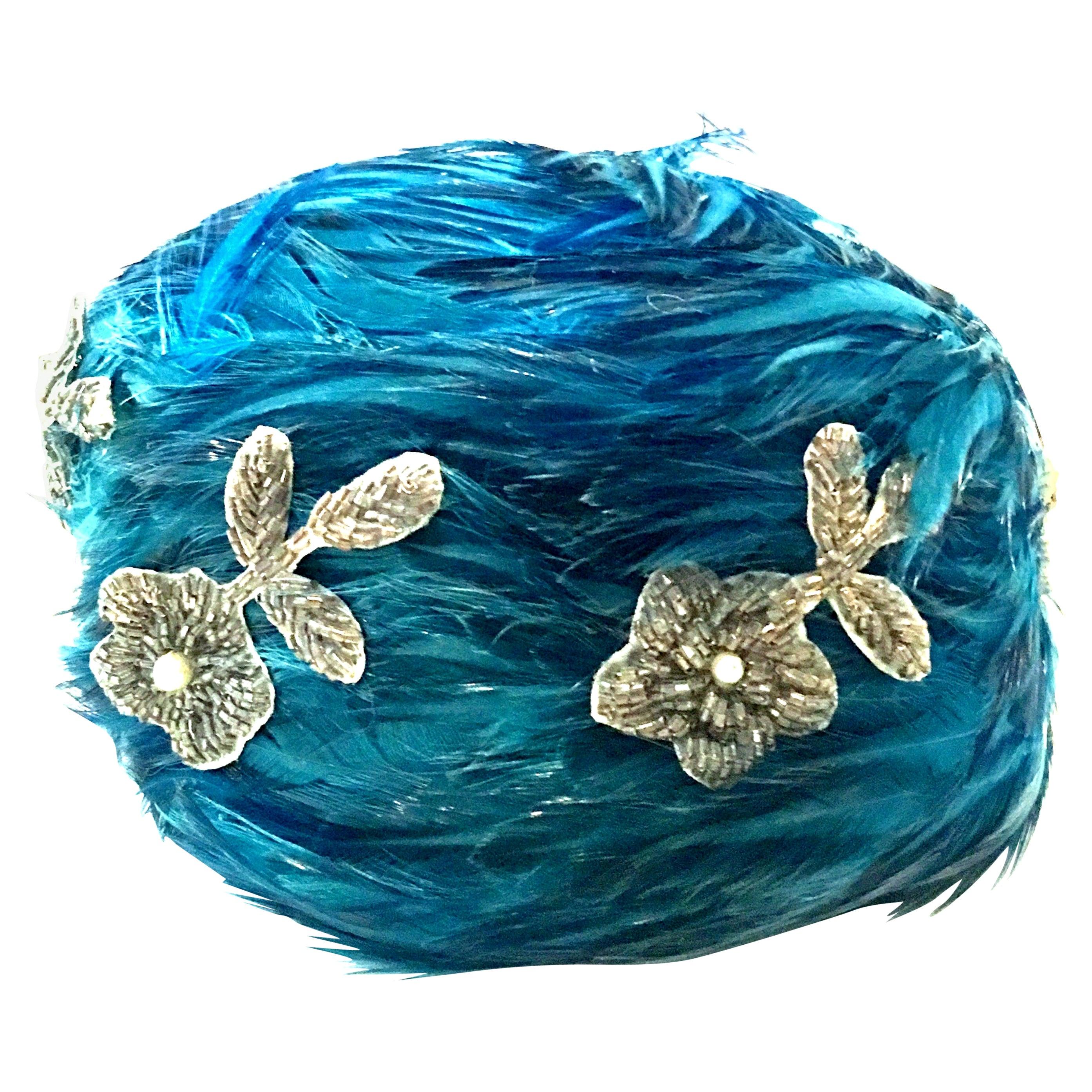 Mid-20th Century Christian Dior Chapeaux French Ostrich Feather & Beaded Applique Hat. This coveted collectors piece features vivid turquoise swirling ostrich feathers with six abstract floral hand glass beaded  and pearl appliques. Signed on the