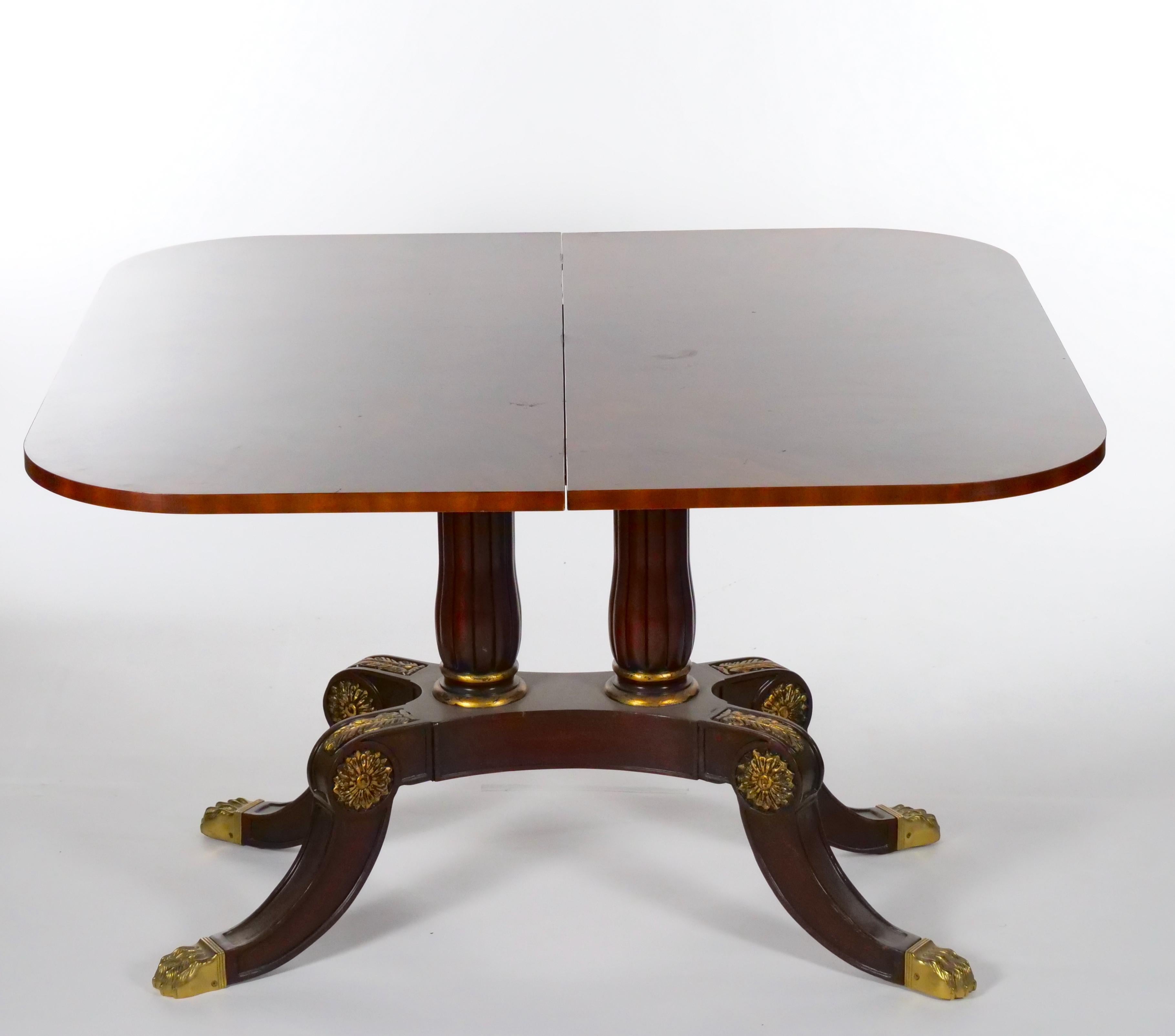 Beautiful Mid-20th Century mahogany wood oval shape neoclassical style small breakfast dining table with brass claw feet details. Close the table measures 28 inches high x 45 inches wide x 22 inches deep. When open the breakfast table can easily