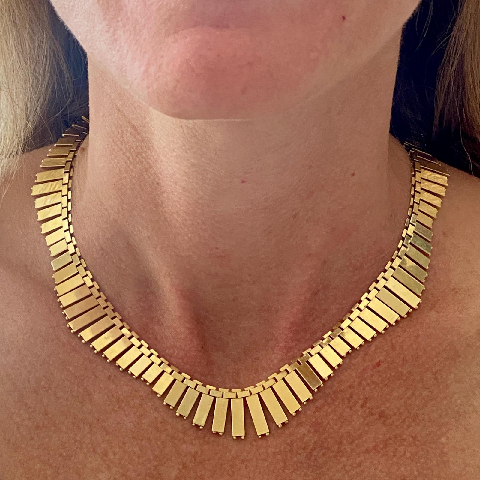 Mid-20th Century Cleopatra necklace fashioned in 14 karat yellow gold. The necklace features fringe drops measuring .75 inches in the front down to .25 inches in the back. The necklace measures 14.5 inches in length, and features Italian hallmarks. 