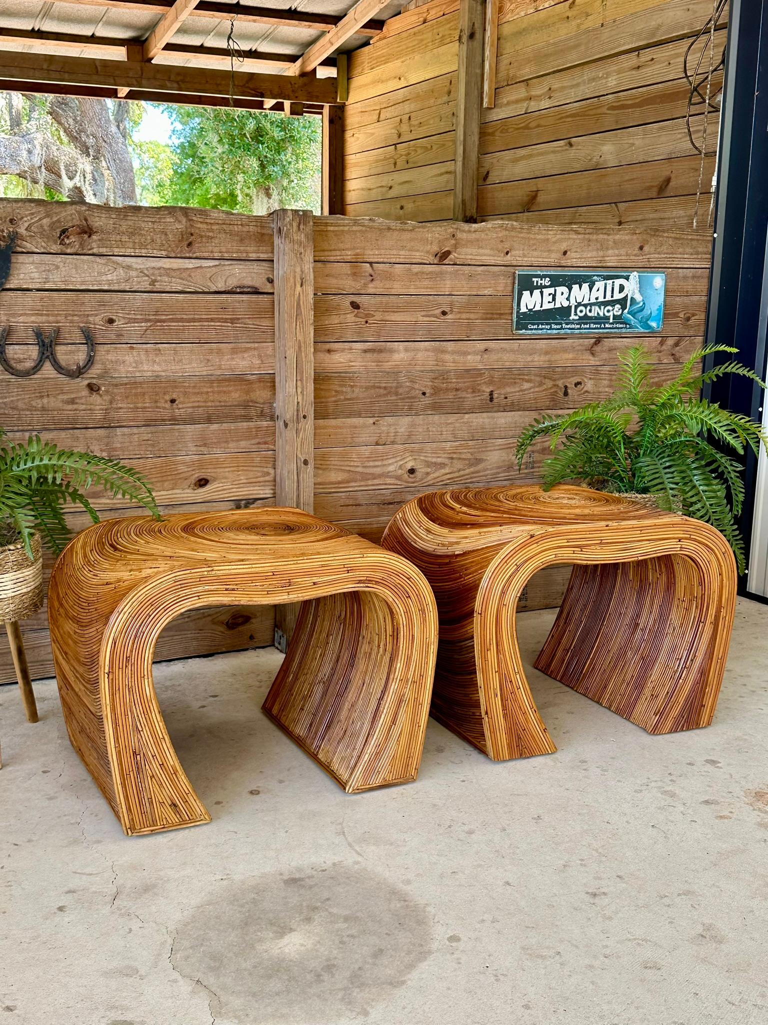 Introducing an exceptional pair of vintage pencil reed rattan side tables, showcasing varying hues of brown and tan in the manner of Gabriella Crespi. These exquisite handmade tables have been refinished while preserving their vintage