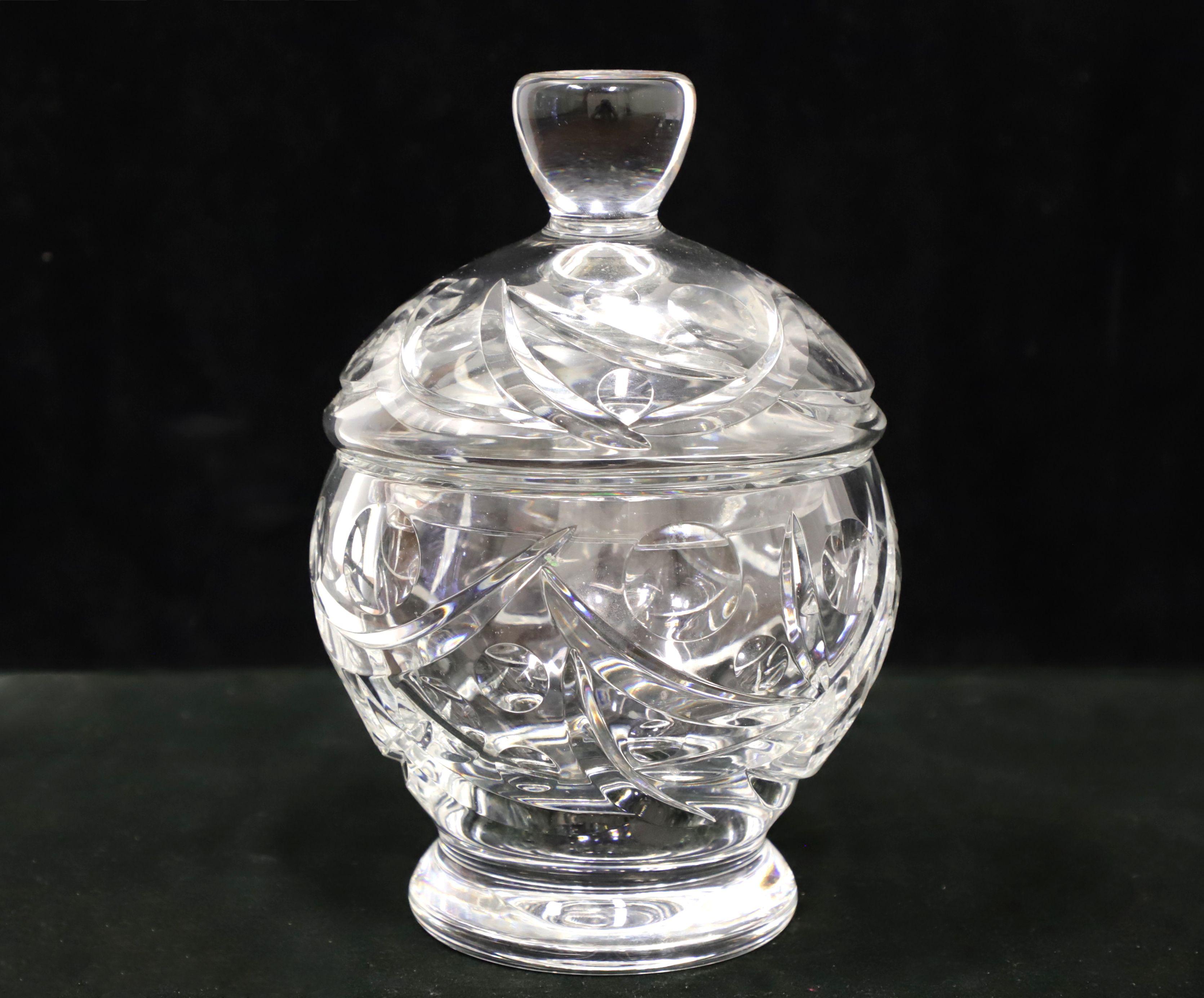 A Mid 20th Century crystal candy dish with lid. Clear crystal round bowl with a cut pattern. Matching clear crystal cut pattern round lid. Origin unknown, most likely the USA.

Measures: 6.25 W 6.25 D 9 H, Weighs Approximately: 6 lbs

Exceptionally