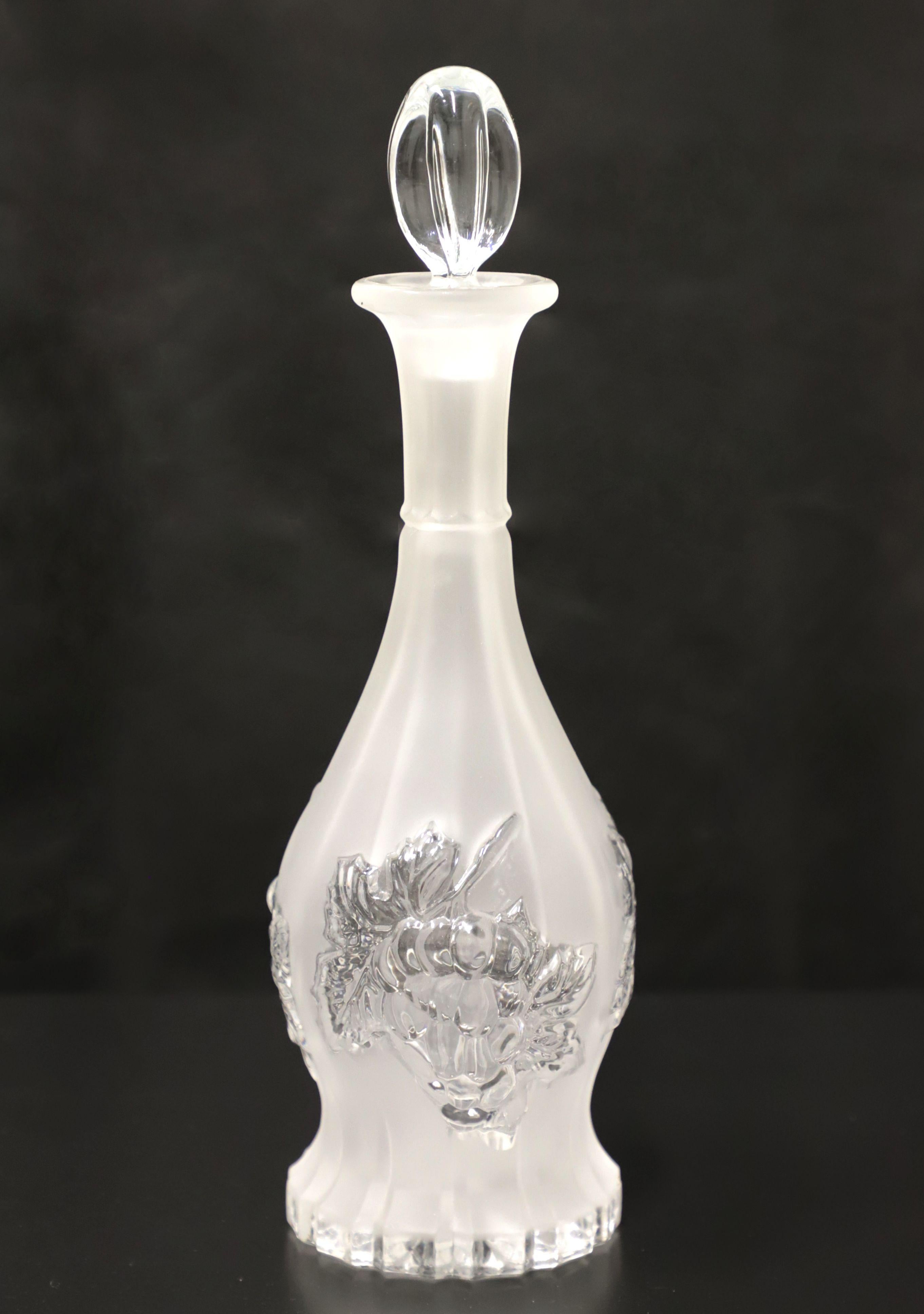 A Mid 20th Century crystal decanter. Frosted crystal decanter with clear grapes & leaves motif and subtle swirl pattern. Clear cylindrical shaped stopper. Origin unknown, most likely the USA.

Measures: 4W 4D 13H, weighs approximately: 3 lbs

Very