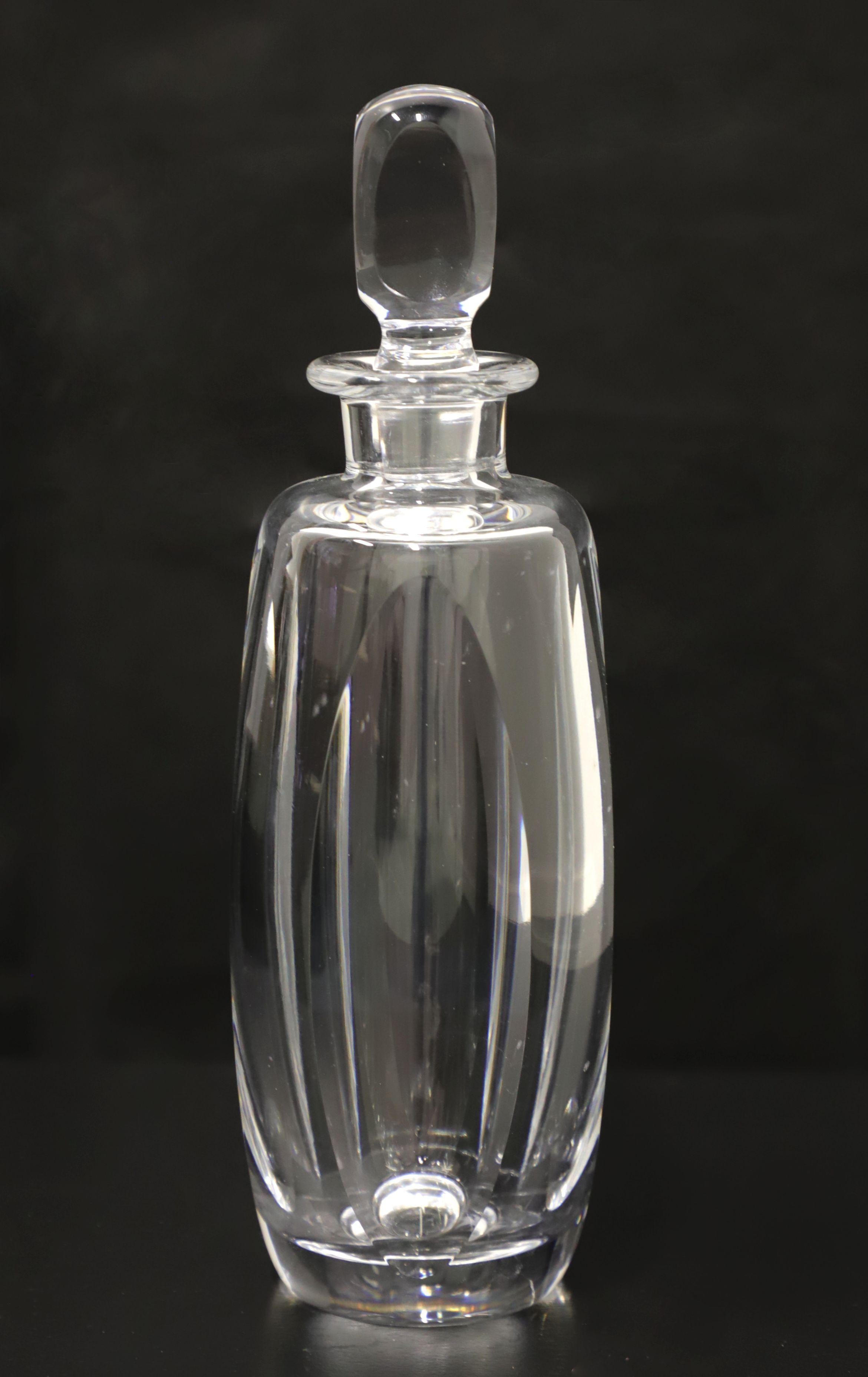 A Mid 20th Century crystal decanter. Clear crystal decanter with cylindrical shape and subtle swirl pattern. Clear cylindrical shaped stopper. Origin unknown, most likely the USA.

Measures: 3.5W 3.5D 11.5H, weighs approximately: 5