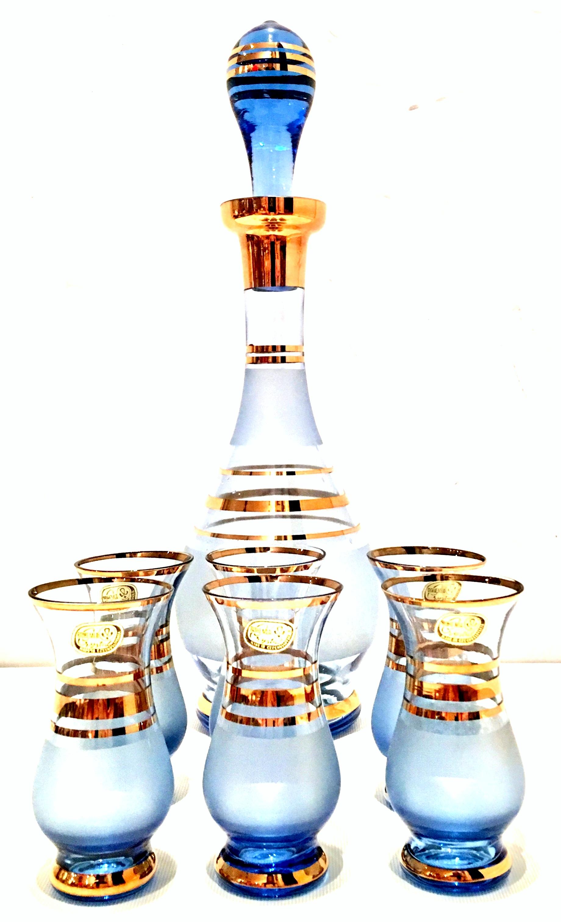 Mid-20th Century crystal Bohemia gilt gold drinks set of seven pieces. This like new blue frosted with 22-karat gold git detail drinks set includes, six cordial cups and one decanter with stopper. Most of the pieces to this set maintain the original