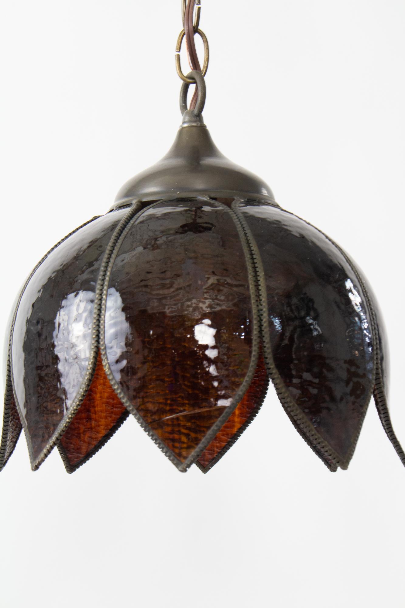 Curved, “slumped” brown art glass panels form a tulip shape. Brass hardware and trim. Single socket, can be used with 100 Watt max bulb. Cleaned and rewired. There is a crack in one of the petals, shown in photos. It is secure in the fixture. The