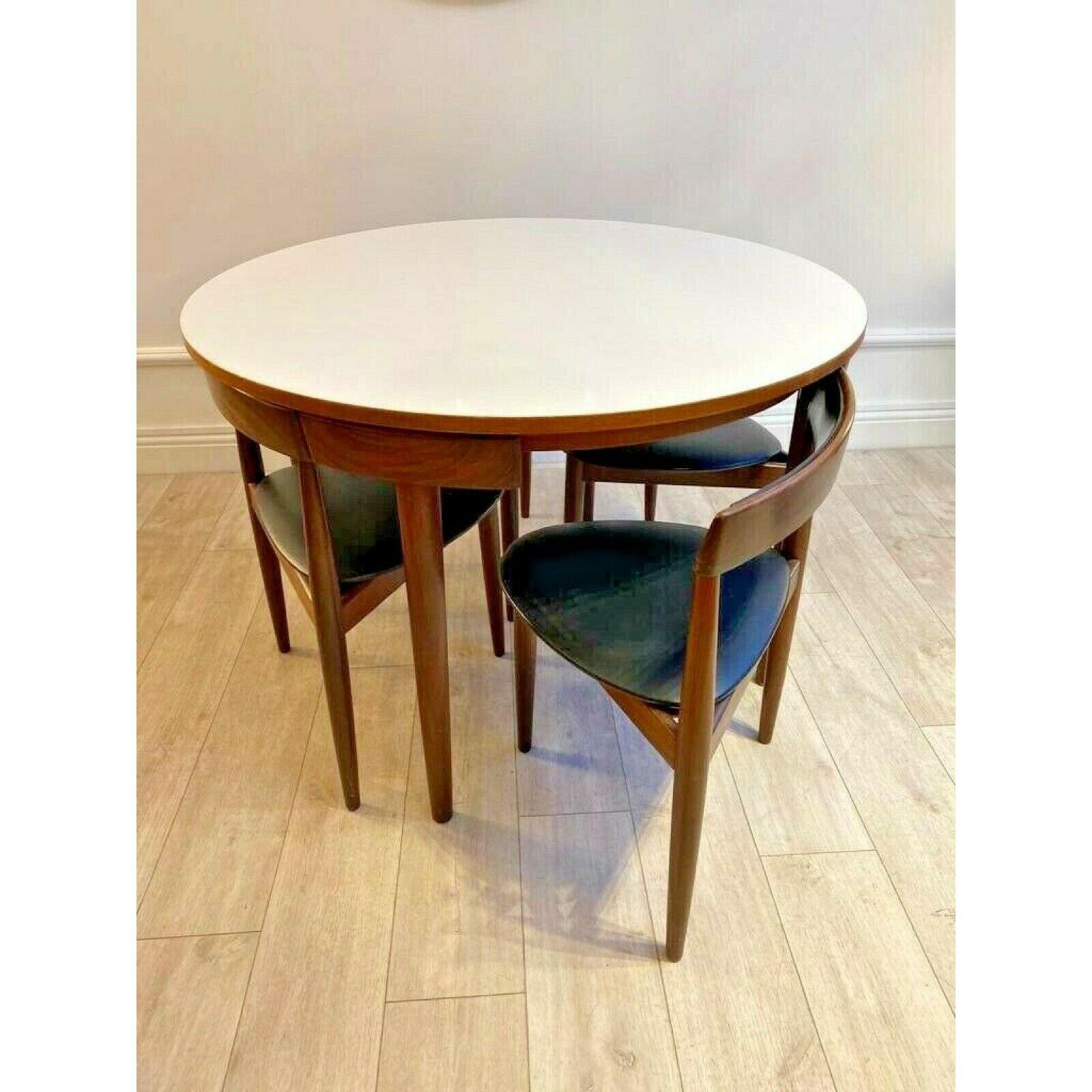 Mid Century Wooden Set of Four Chairs and matching table 

Teak dining table with a white formica top and Four chairs 'Roundette' model designed by Hans Olsen and produced by Frem Røjle 1960s 

Compact dining set for four, in this iconic design