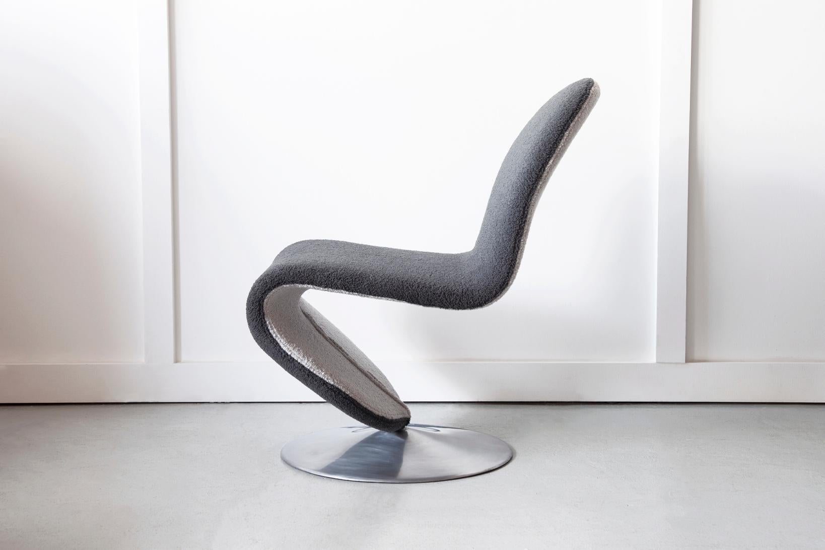 An iconic and original system 1-2-3 occasional chair, designed by Verner Panton and produced by Fritz Hansen in the 1970's. Newly upholstered in contrasting grey bouclé.