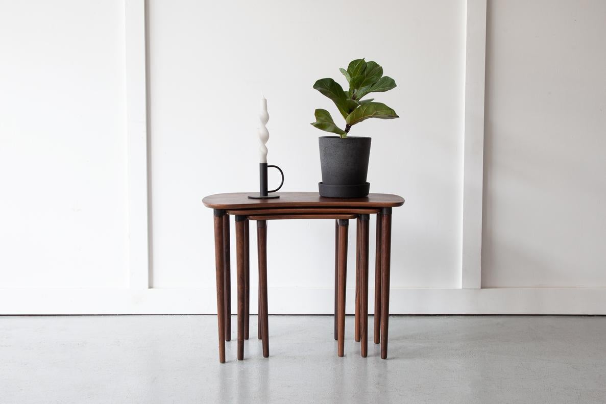 A rare set if kidney shaped nesting tables in solid Brazilian rosewood by Dansk Design, manufactured in Denmark. Their organic form is what makes them very special and a real statement piece. All three have beautiful grain details and stand on long