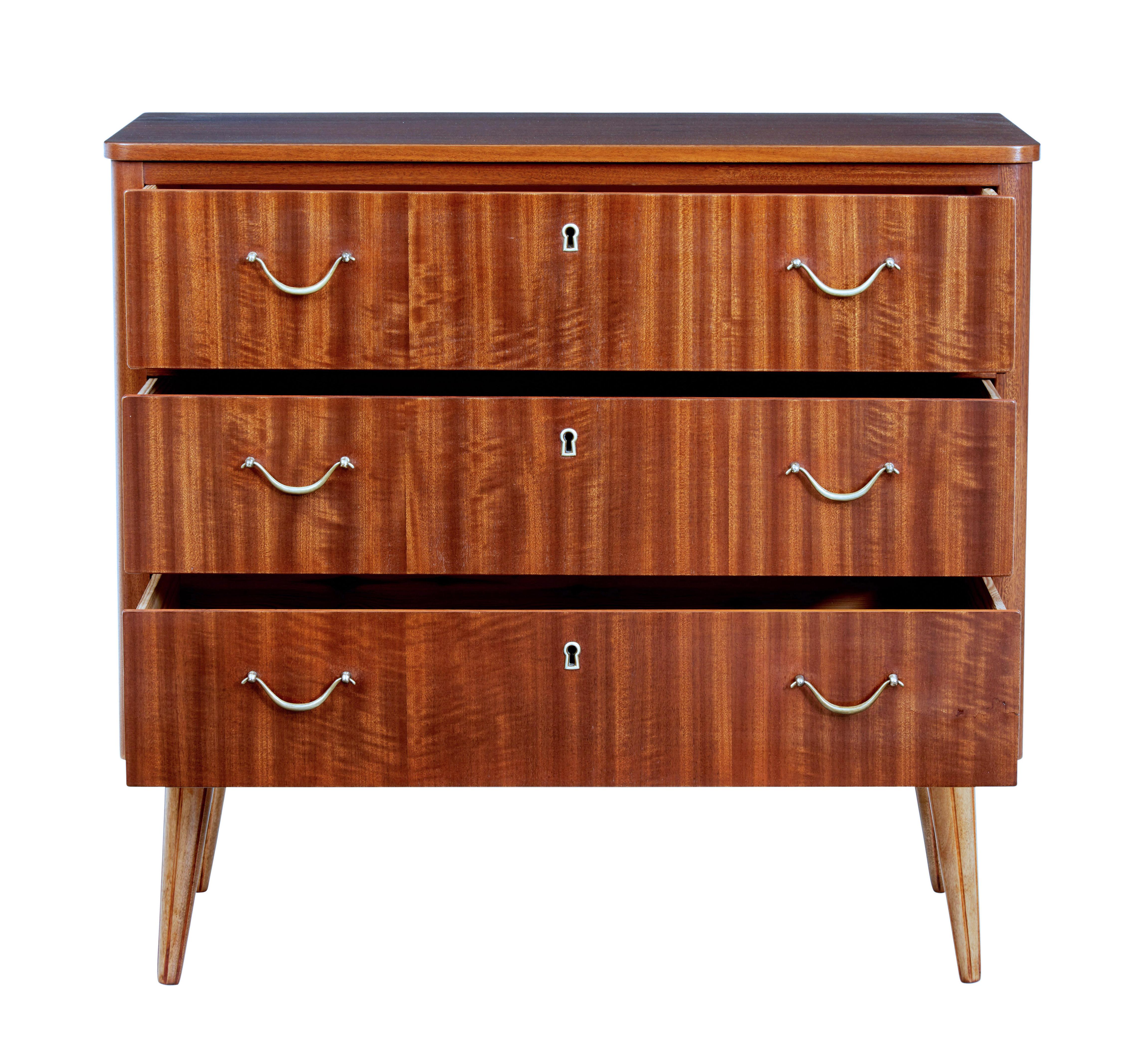 Mid 20th century Danish small teak chest of drawers circa 1960.

3 drawers fitted with brass looped handles.  Rich colour and unusually for teak polished surface.

Standing on tapered legs.

Light staining to top surface.