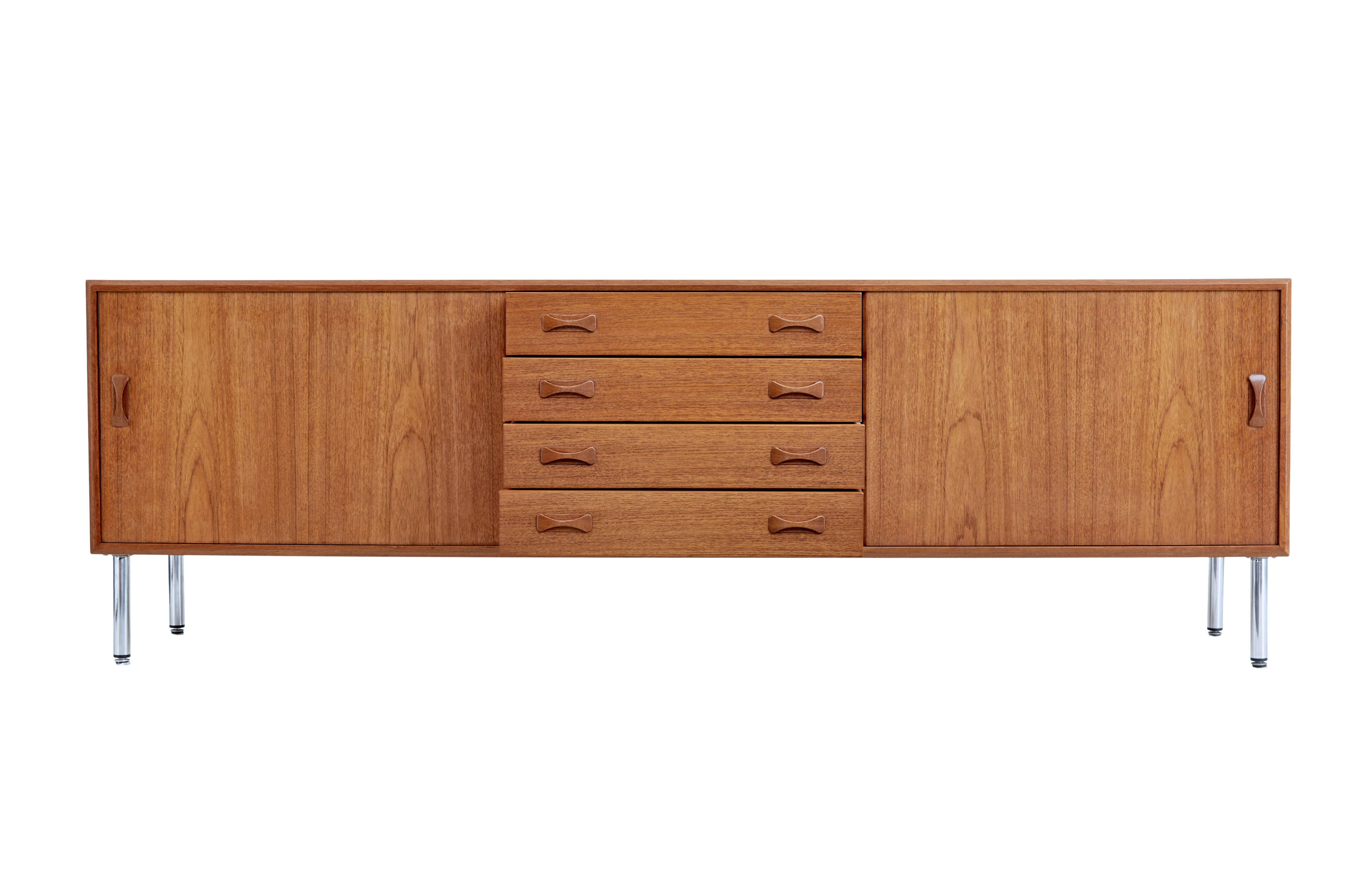 Mid-20th century Danish teak sideboard by Clausen & Sons, circa 1960.

Good quality Danish teak sideboard by Danish makers Clausen & Sons, circa 1960. Central bank of 4 drawers, flanked either side by a sliding door to reveal a single shelf. Good