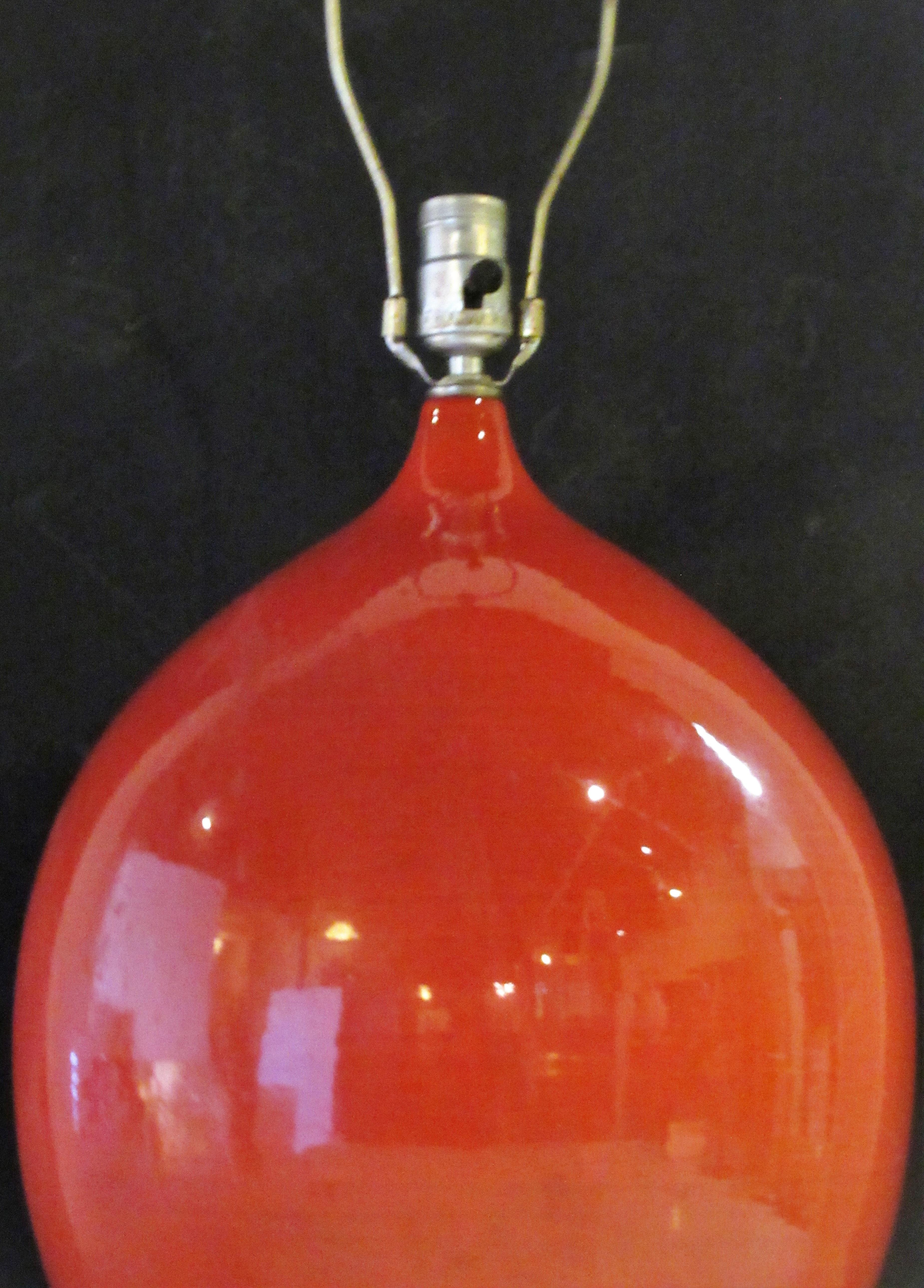 A beautiful deep orange glazed ceramic table lamp with a great looking large bulbous ovoid form, circa 1950-1960.