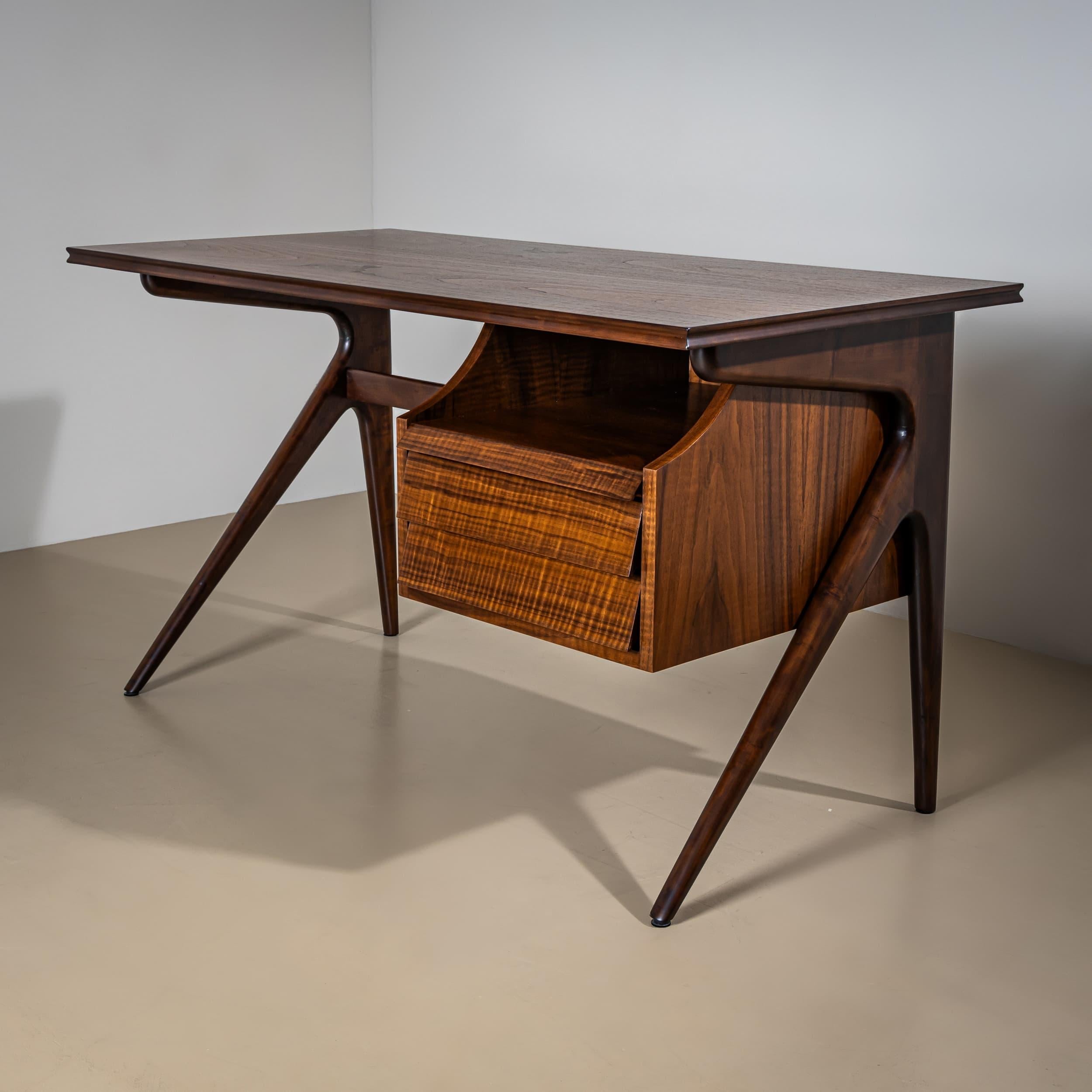 Mid-20th century desk featuring two drawers on the right side, flared legs, and a rectangular top with elegant profiling. The back is fully veneered and showcases an intricate diamond-shaped inlay pattern on the rear panel of the drawer section. The