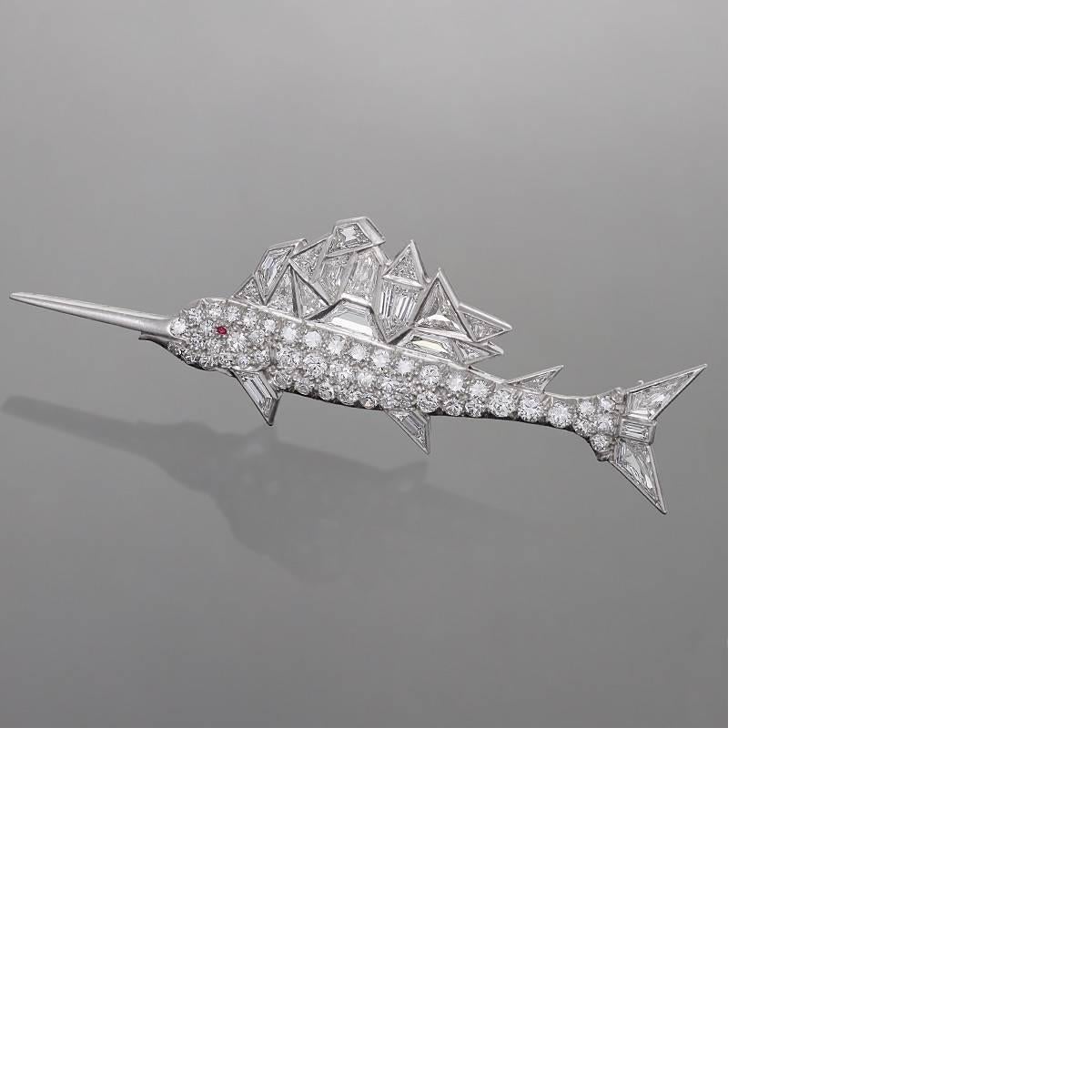 A Mid-20th Century platinum brooch with diamonds in the shape of a sailfish. The brooch has 21 mixed fancy-cut diamonds with an approximate total weight of 3.00 carats, and 48 round-cut diamonds with an approximate total weight of 1.50 carats. Total