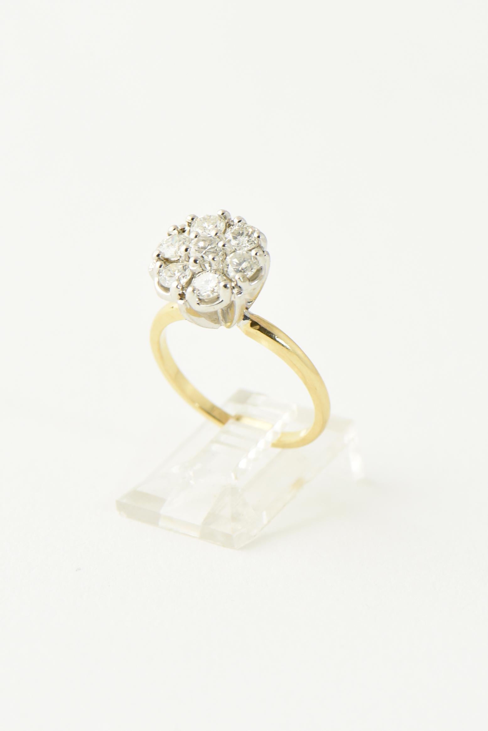 Mid 20th century 10K yellow gold and white gold diamond cluster ring. featuring a floral design.  Approximately 1 carat of SI2 - HI diamonds. Marked: 10K. US size 6.5; can be sized.