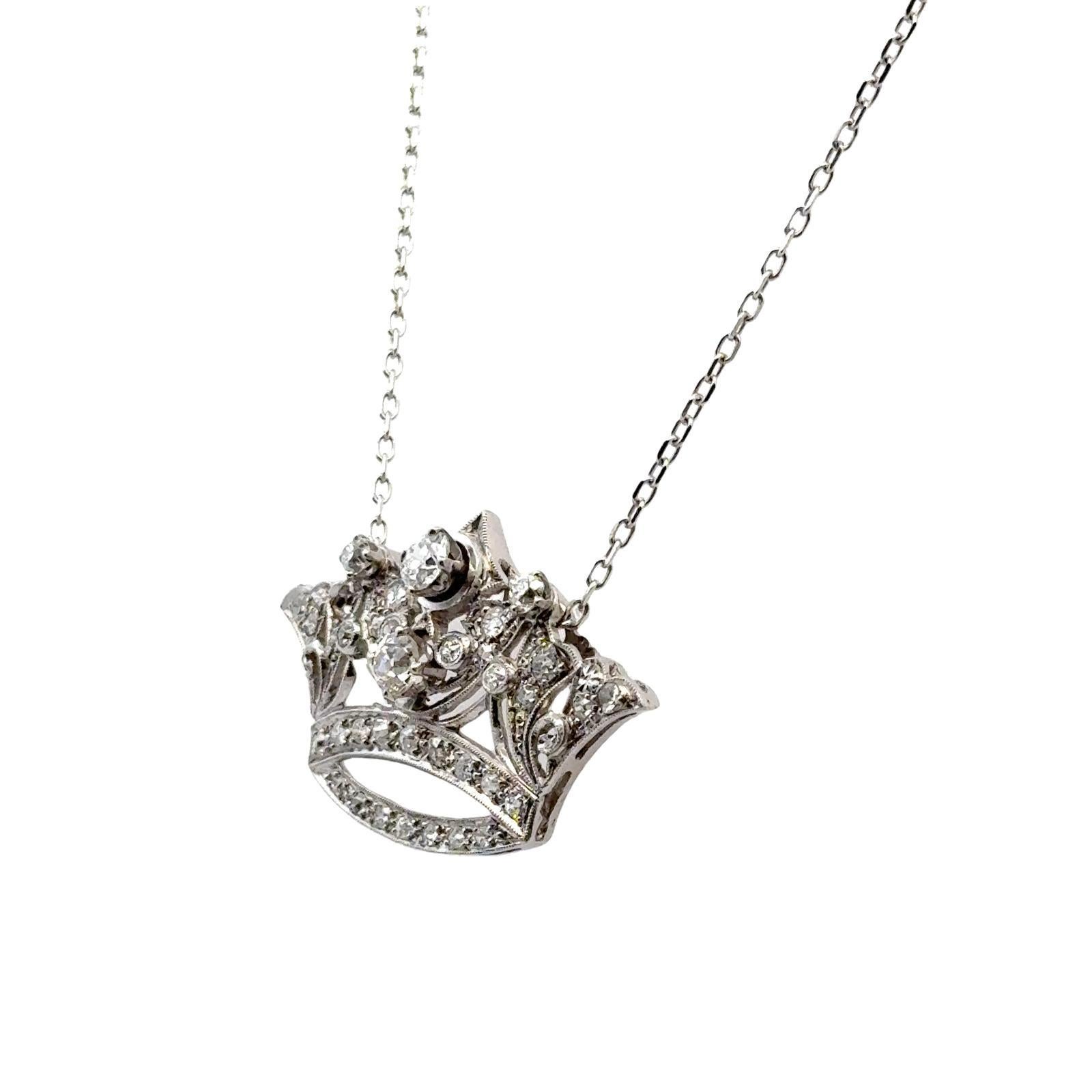 This platinum diamond crown pendant exudes regal elegance and timeless beauty. The pendant is adorned with diamonds totaling approximately 1.75 carats, graded H-I in color and SI in clarity, offering a radiant sparkle. Measuring 22mm by 34mm, the