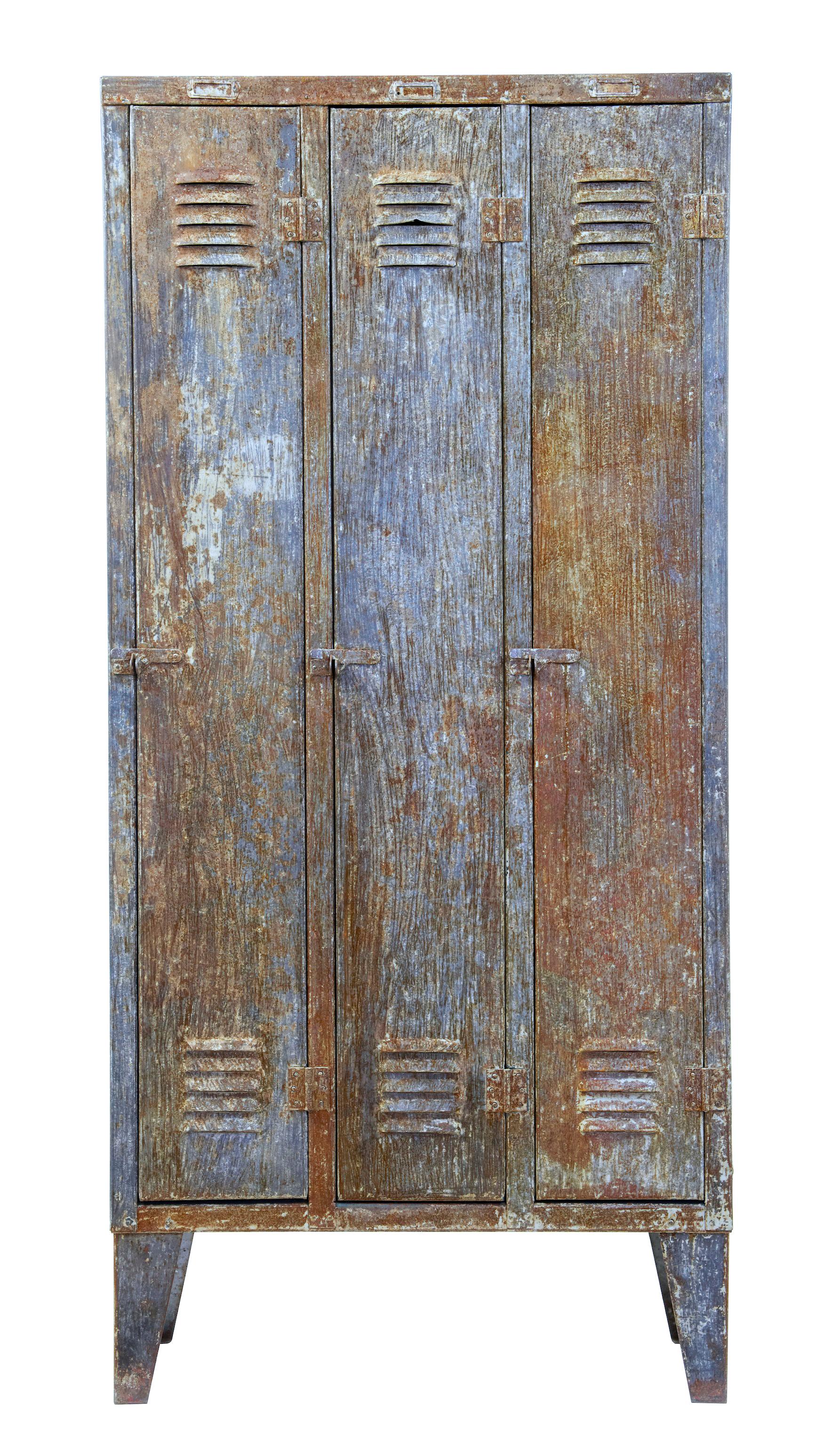 Mid-20th century distressed industrial cabinet, circa 1960.

3-door cabinet with a single shelf in each compartment. Metal distressed to give a weathered appearance.