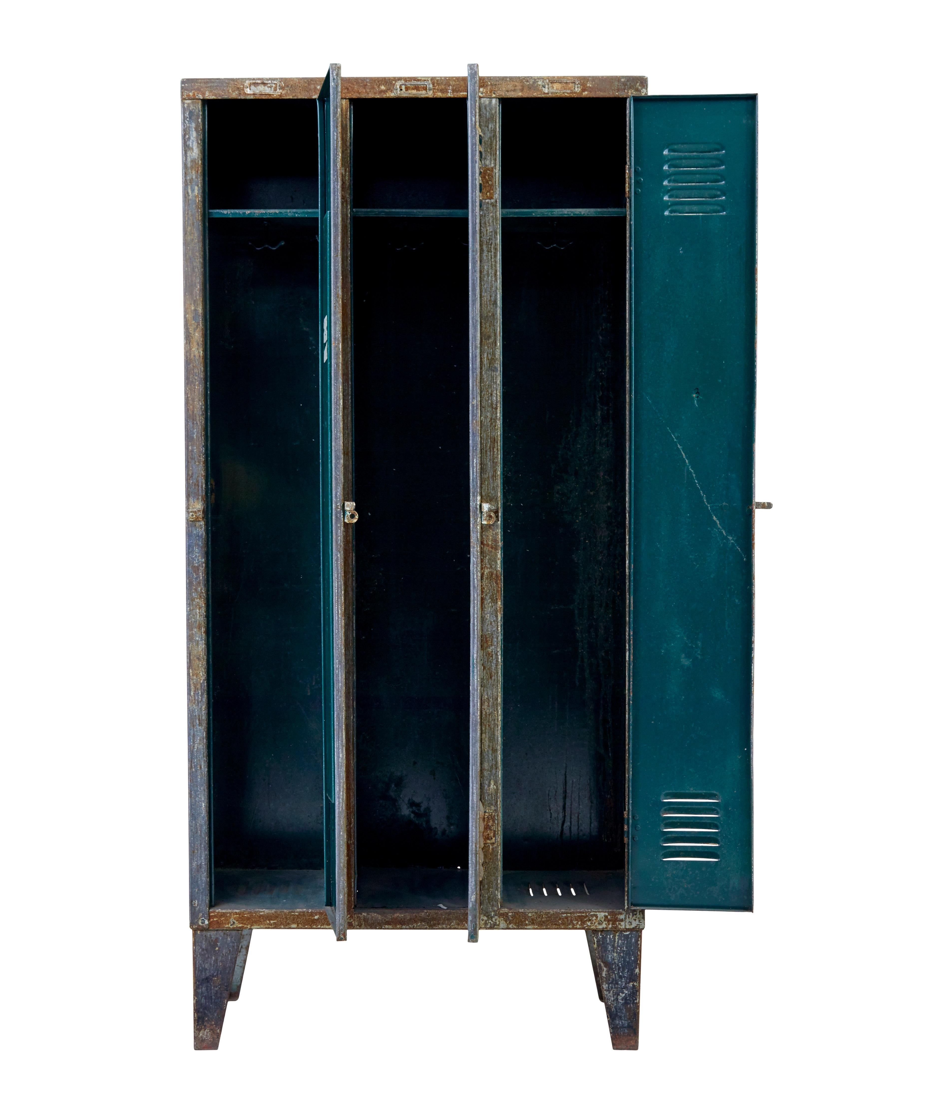 Mid 20th century distressed industrial cabinet circa 1960.

3 door cabinet with a single shelf in each compartment.

Partially stripped back to bare metal some years ago this piece has now taken on a weathered and distressed appearance.

Ideal for