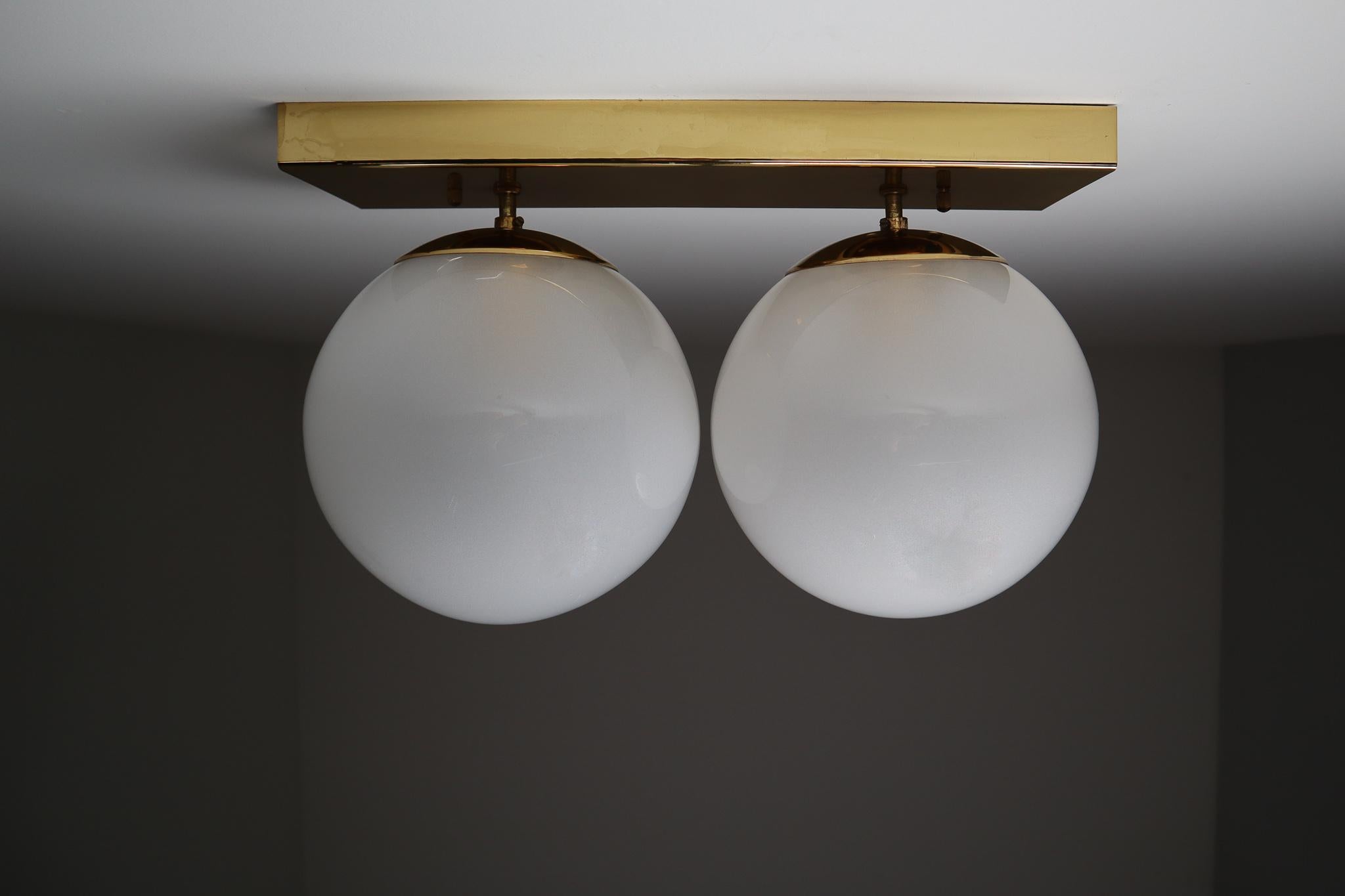 European Mid-20th Century Double Brass Wall Scones with Hand Blowed Frosted Glass Globes For Sale