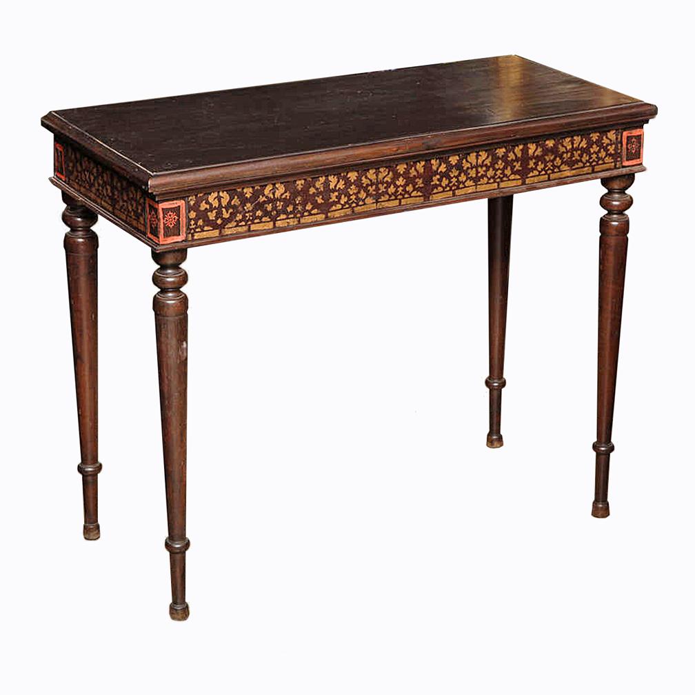 A Dutch Colonial style console table, from Sien Reap, Cambodia, circa 1950. The hand painted apron in red and gold adds an exotic touch to this charming piece. Small and very well preserved, this console can add a warm, nostalgic accent to