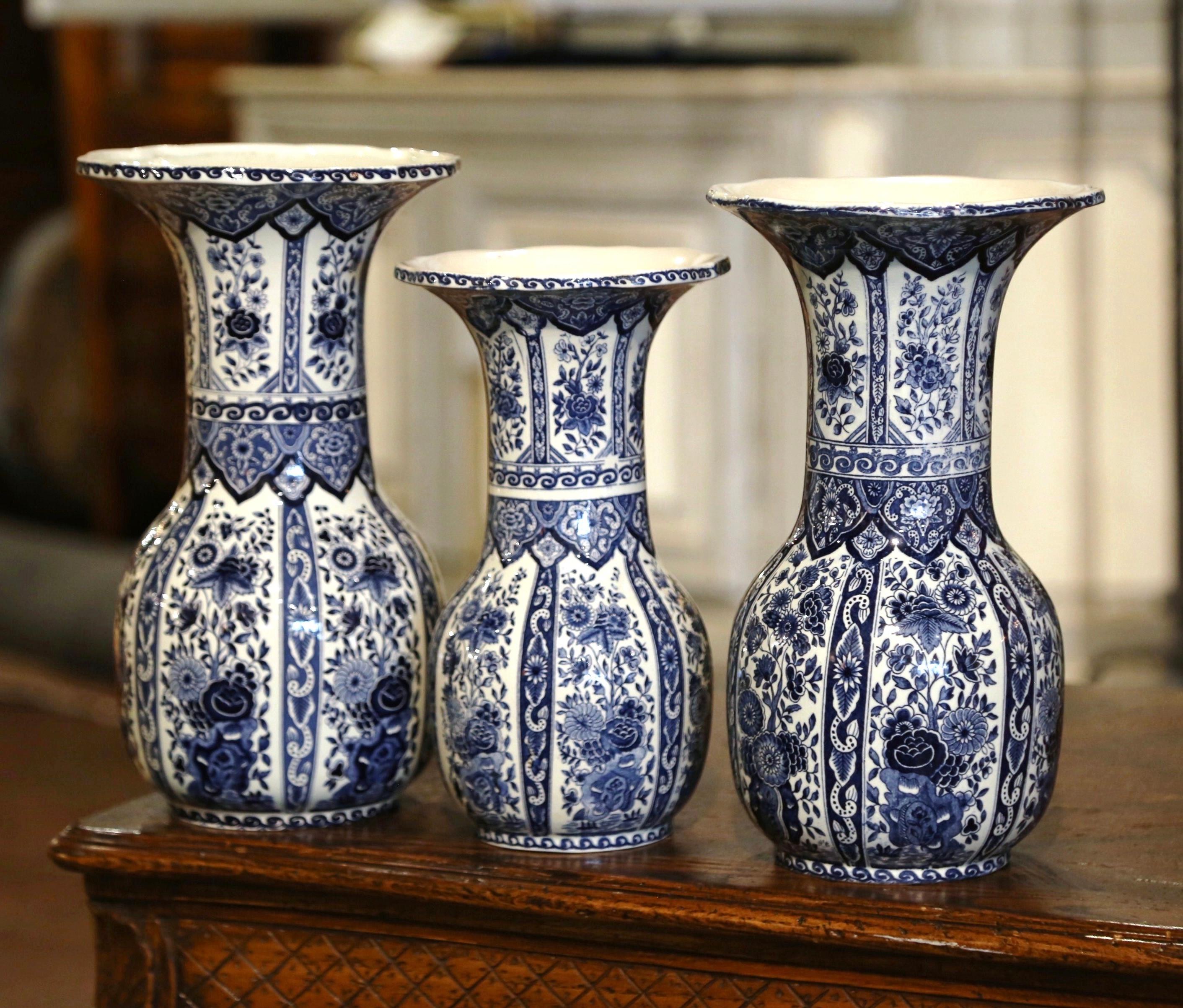 Decorate a mantel or a shelf with this elegant set of colorful vases of different heights. Created by Delft in the Netherlands, circa 1940, each ceramic vessel is round in shape with a long neck and wide mouth; each vase features classic hand
