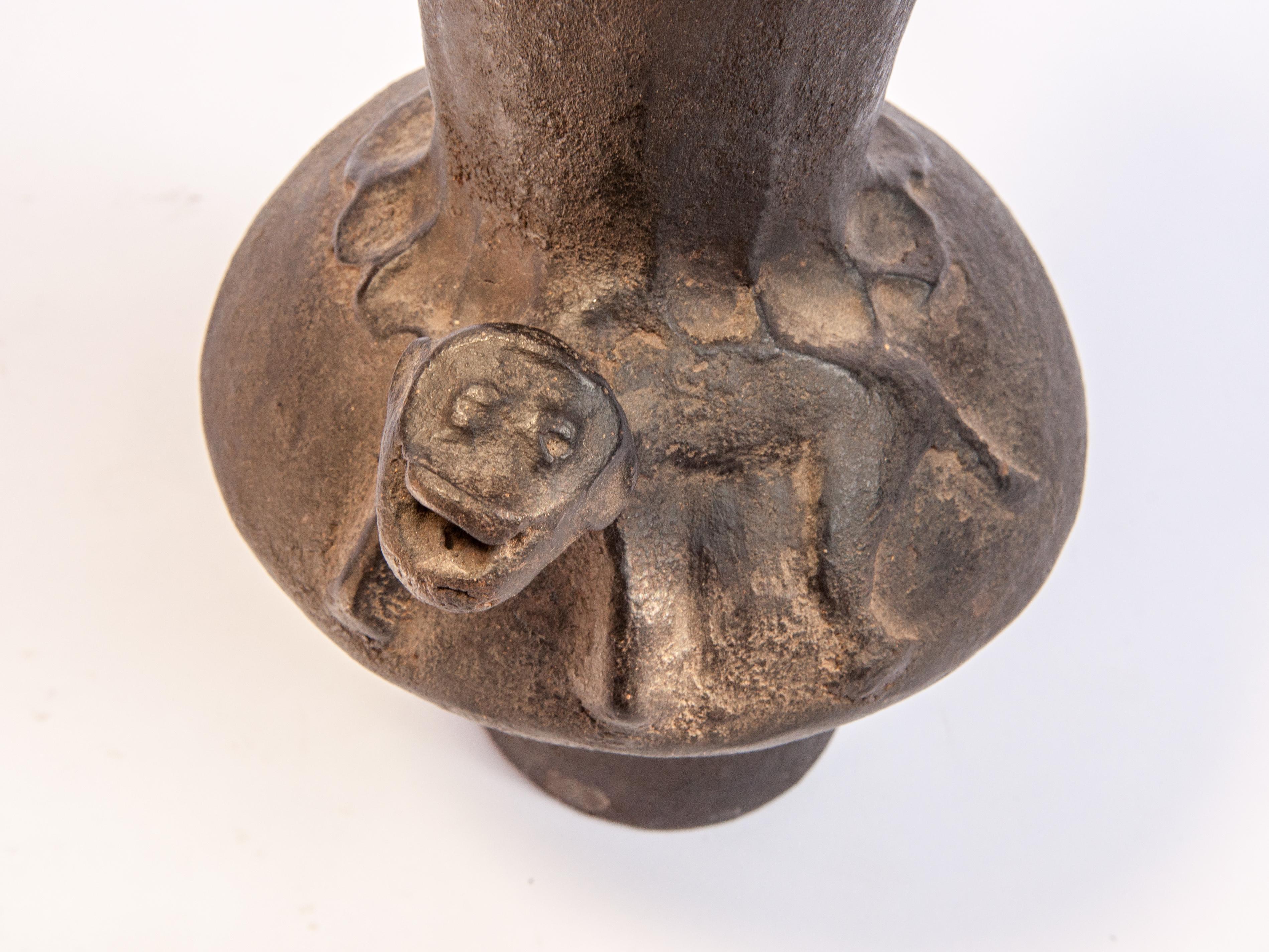 Mid-20th century Earthenware pot from Sumba, East Indonesia, with monkey motif. 9.5 inches tall.
This low fired and hand shaped pot comes from the eastern Indonesian island of Sumba, and was most likely used to prepare herbal mixtures or medicines.