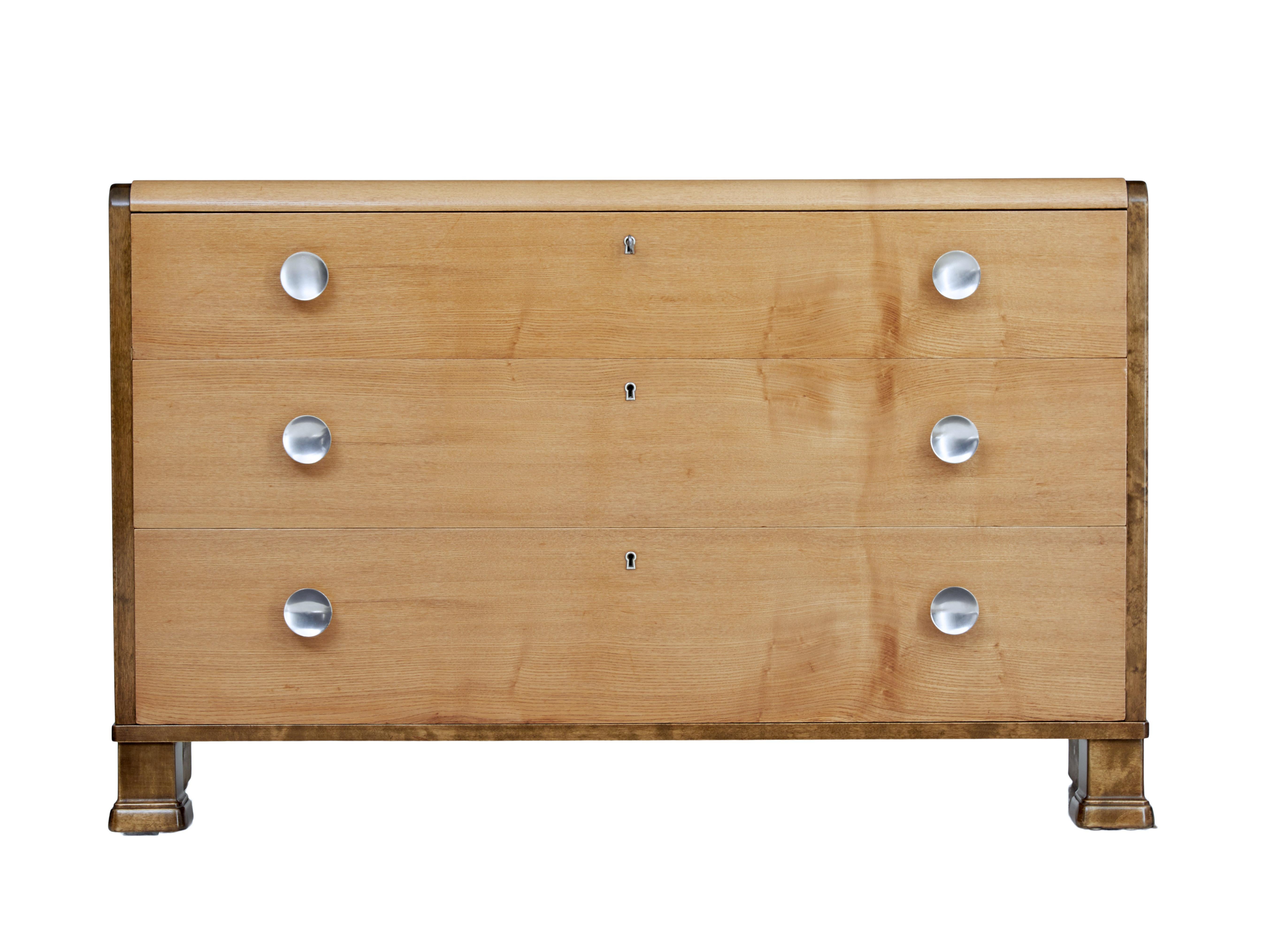 Mid-20th century elm and birch Scandinavian chest of drawers, circa 1960.

Fine quality chest of drawers. Fitted with 3 graduating drawers veneered in elm which also covers the top. Dark stained birch sides which flow down to the sledge
