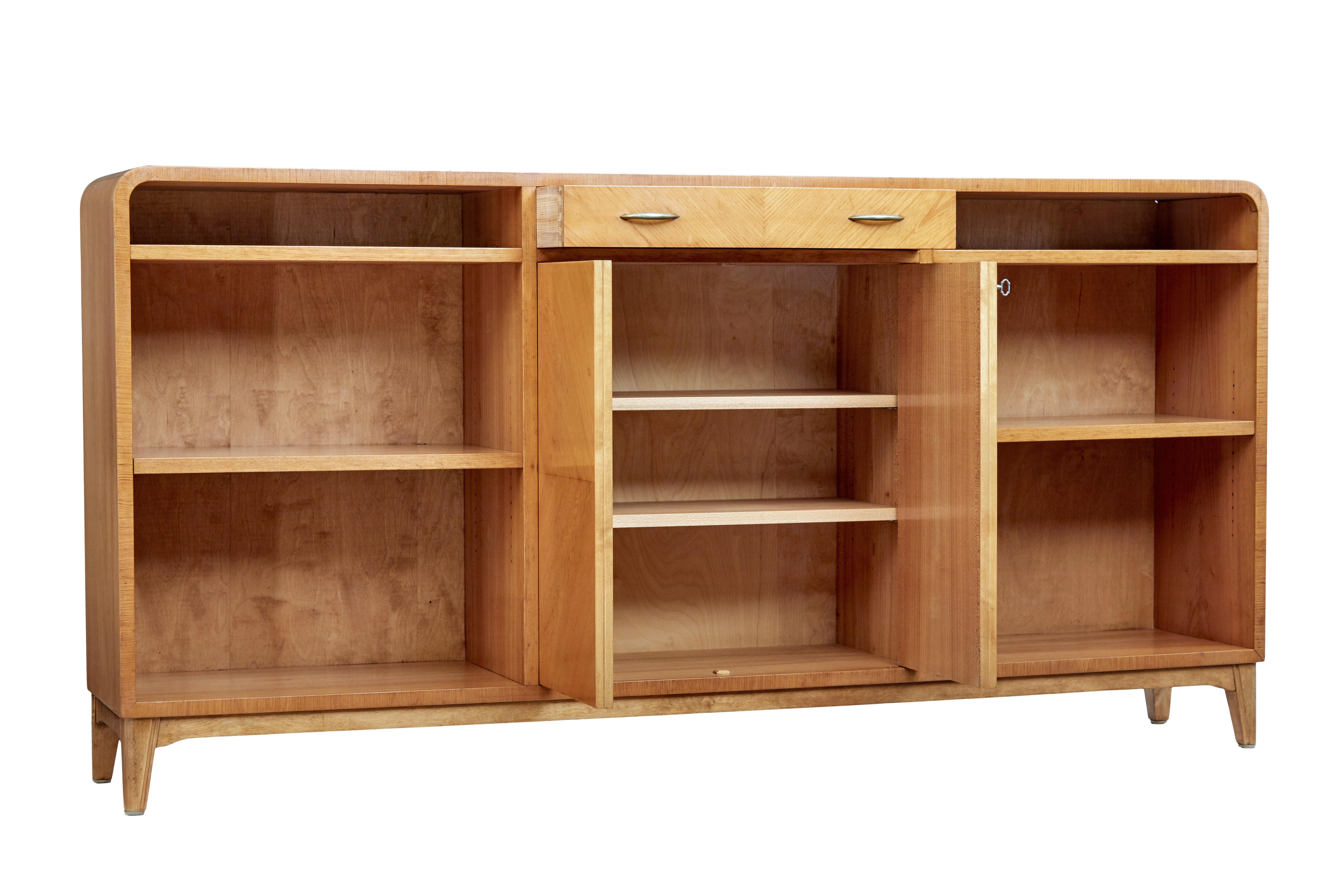 Mid-20th century elm low open bookcase by Bodafors, circa 1950.

Fine quality Scandinavian Modern midcentury bookcase, made by well known makers bodafors. (makers stamp on the reverse). Shaped ends, with central drawer below the top surface