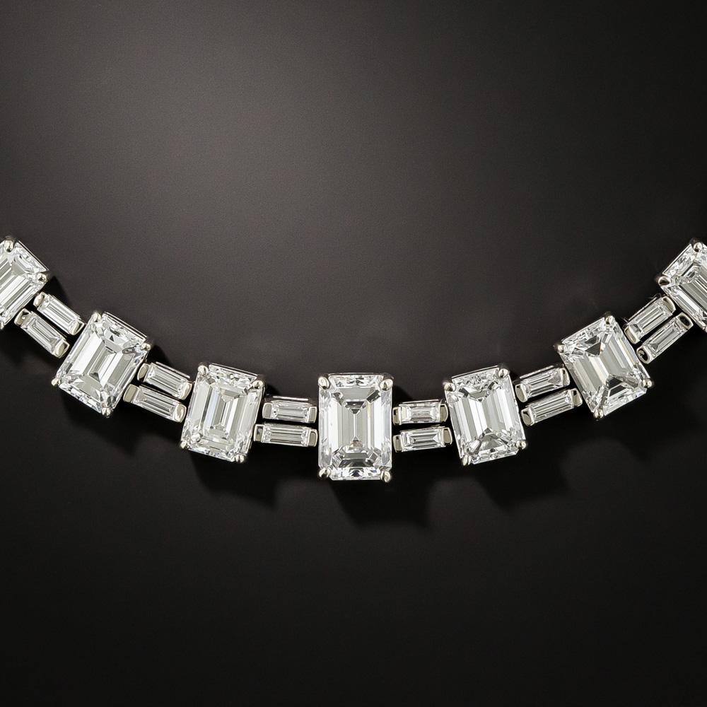This refined and ravishing formal dress necklace radiates all around with 49 perfectly matched, icy-white emerald-cut diamonds - all together weighing 26.00 carats - plus 7.00 carats total weight of the interspersed pairs of gleaming white baguette