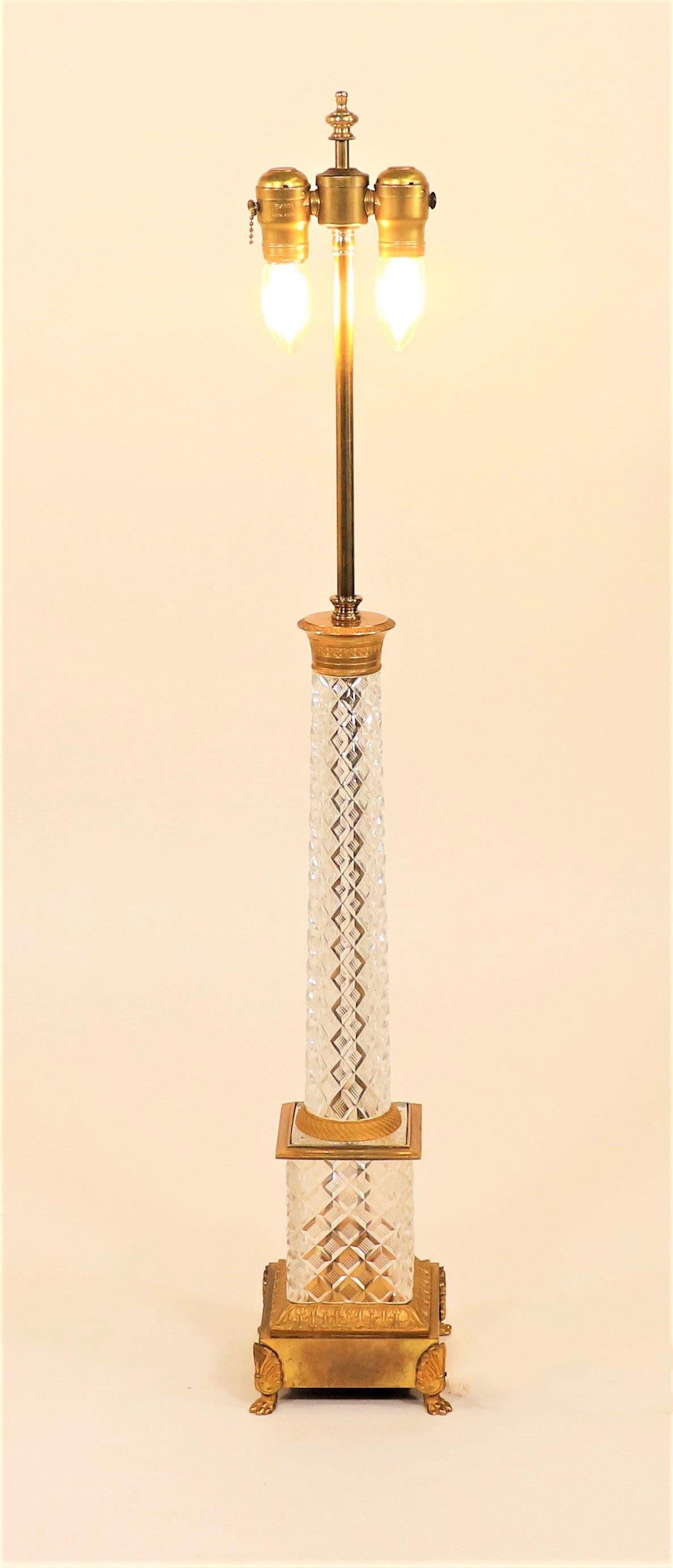A Mid-20th Century Empire Style Austrian crystal pedestal with gilt bronze and brass capital and base raised on a plinth with lion paw feet. Marked 