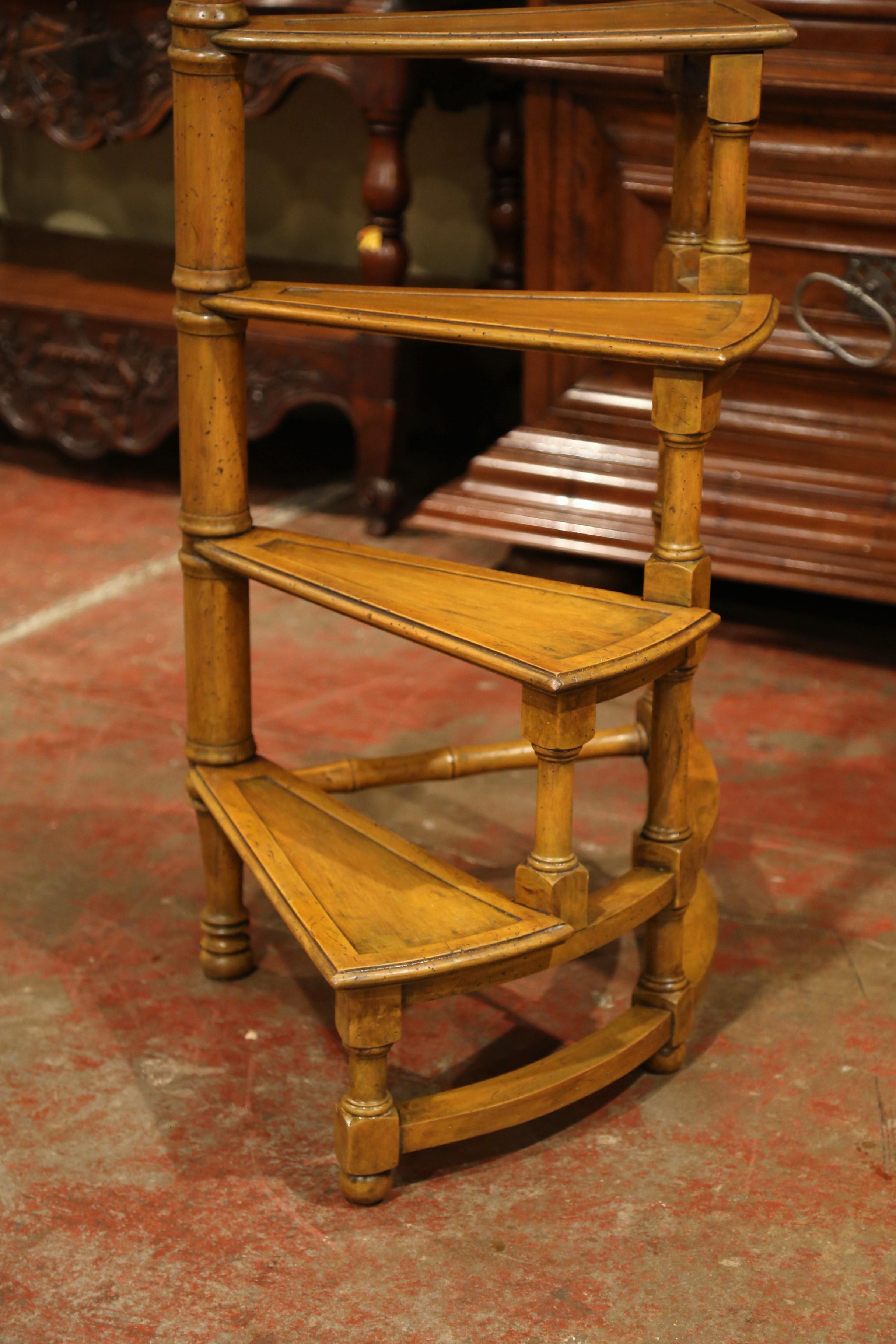This tall Victorian fruit wood library stairs with turned legs and central post was created in England, circa 1950. The thin stairs come from a central, turned circular steps and spiral out for extra height with a slim profile. The steps are in