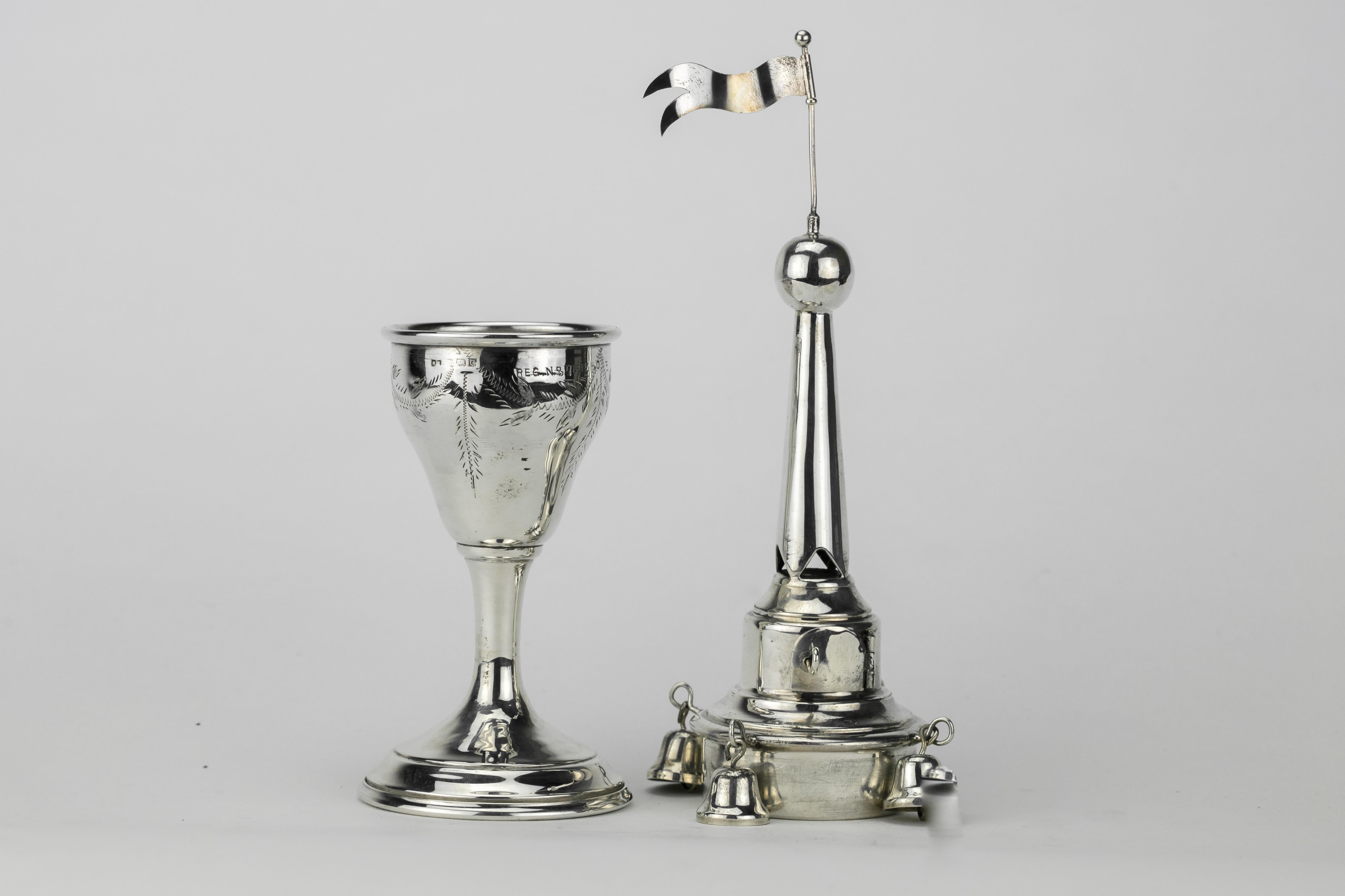 Unusual sterling silver combined spice box and Kiddush goblet by Nathan Shore, London, England, 1958. The goblet with an elegant stem, on round base, is engraved with leaves around the cup, the spice container with hinged door is decorated with four