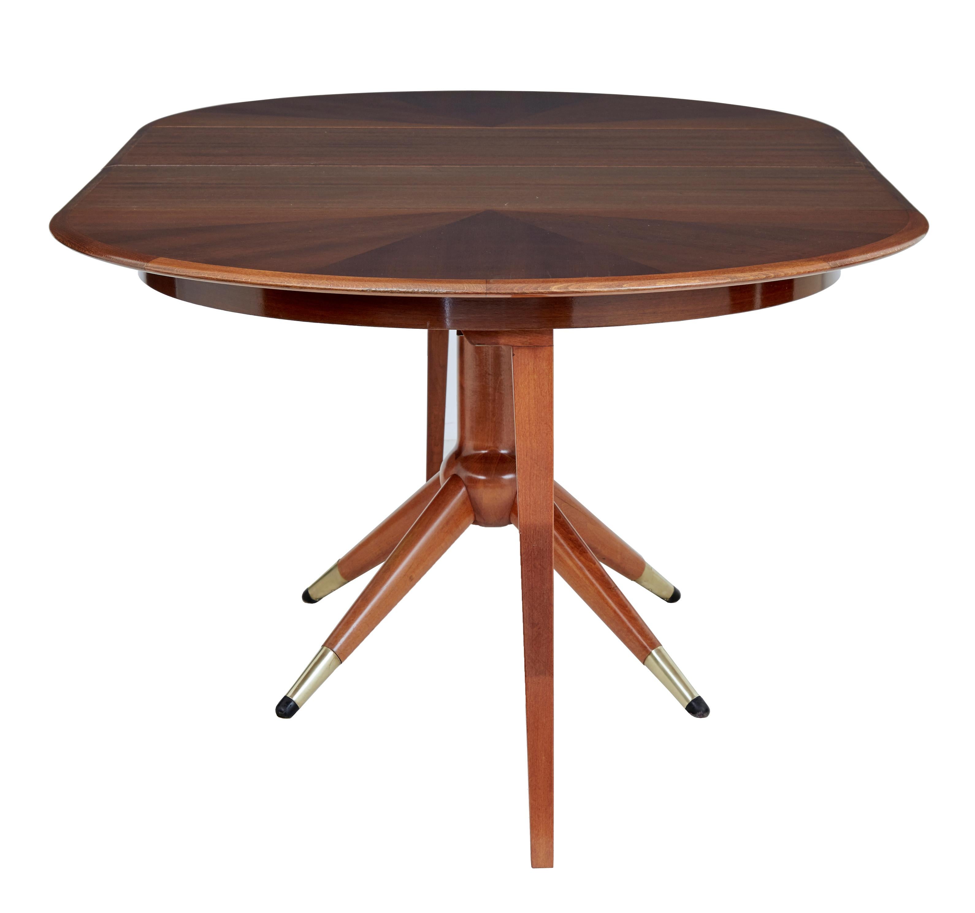 Mid 20th century extending teak dining table by david rosen circa 1950.

Here we have a good example of the 'napoli' table designed by david rosen for nordiska kompaniet.

Circular segmented veneered top with solid teak edge, supplied with 2