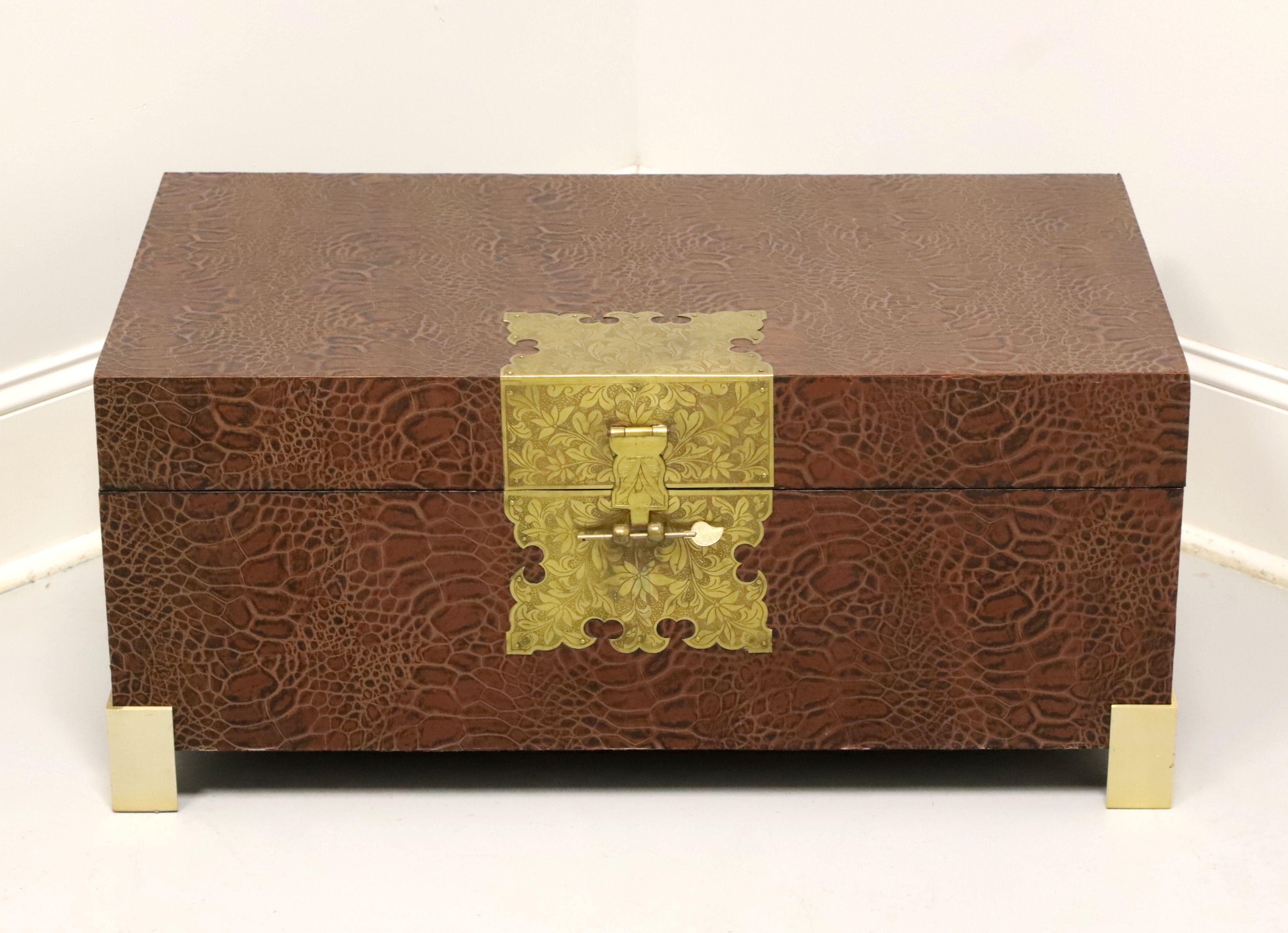 An Asian chinoiserie style faux reptile leather trunk, unbranded. Wood frame covered with artificial reptilian leather, decorative brass hardware, non-locking decorative Asian key, Dual brass handles and brass feet. Features roomy interior and paper