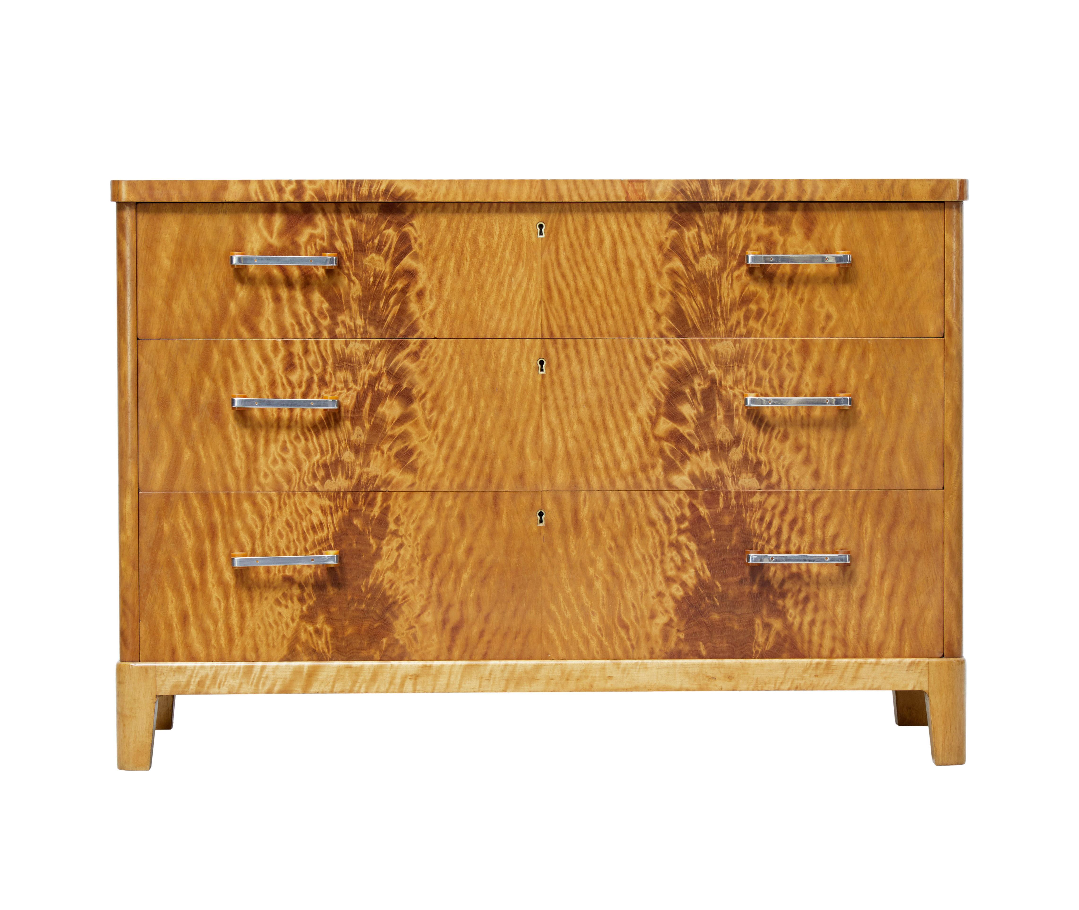Mid-20th century fine burr birch Scandinavian Modern chest of drawers, circa 1950.

Possibly early than 1950 this deco inspired chest features striking veneers. 3 graduating drawers to the front, fitted with Bakelite and steel handles. Oak lined