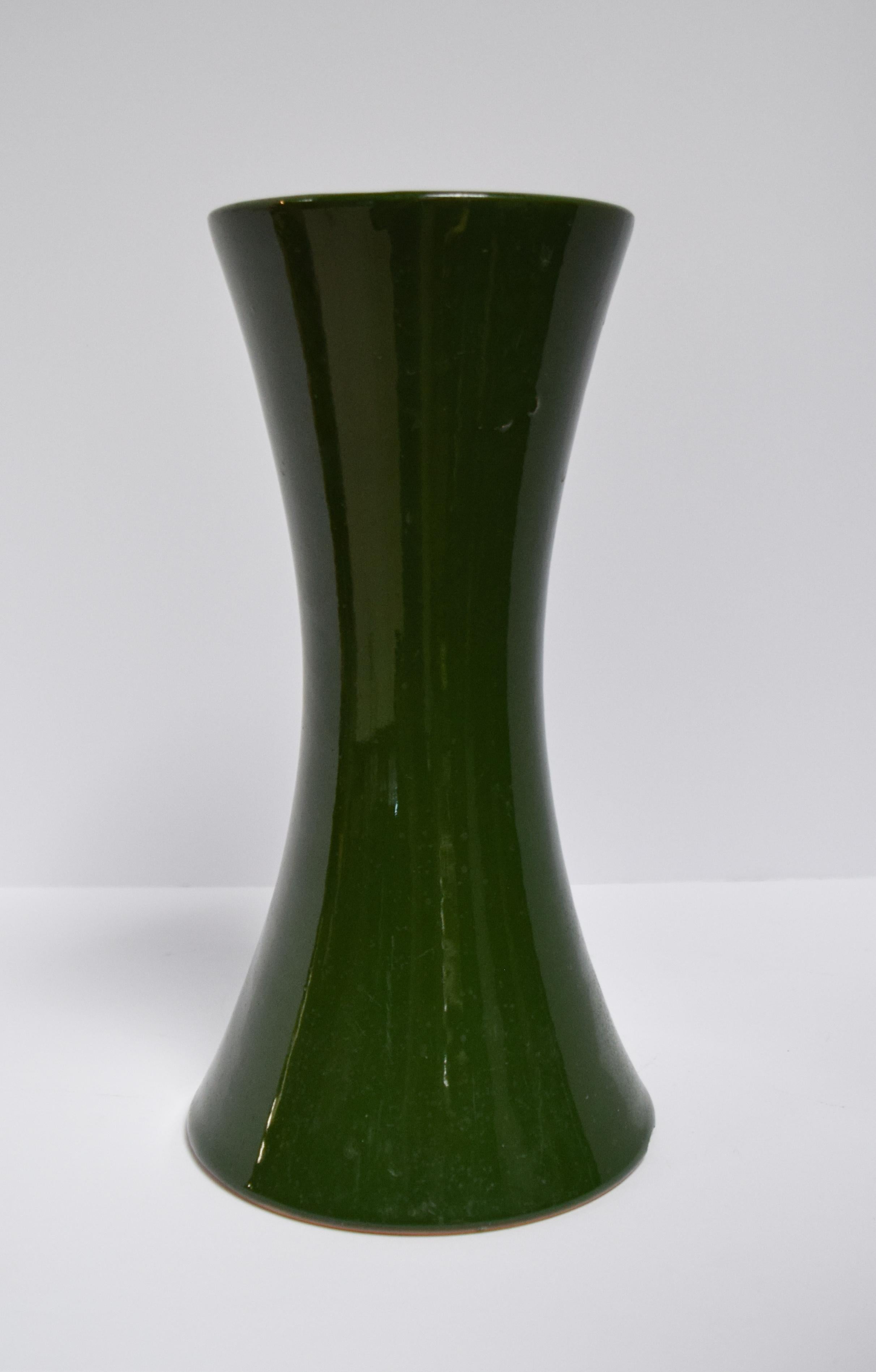 These vases are souvenirs from floral competitions of the 1850s. With an attractive hourglass shape, these vases are the ideal shape for floral arrangements. The structural flair is still incredibly stylish and with its eye-catching bottle green