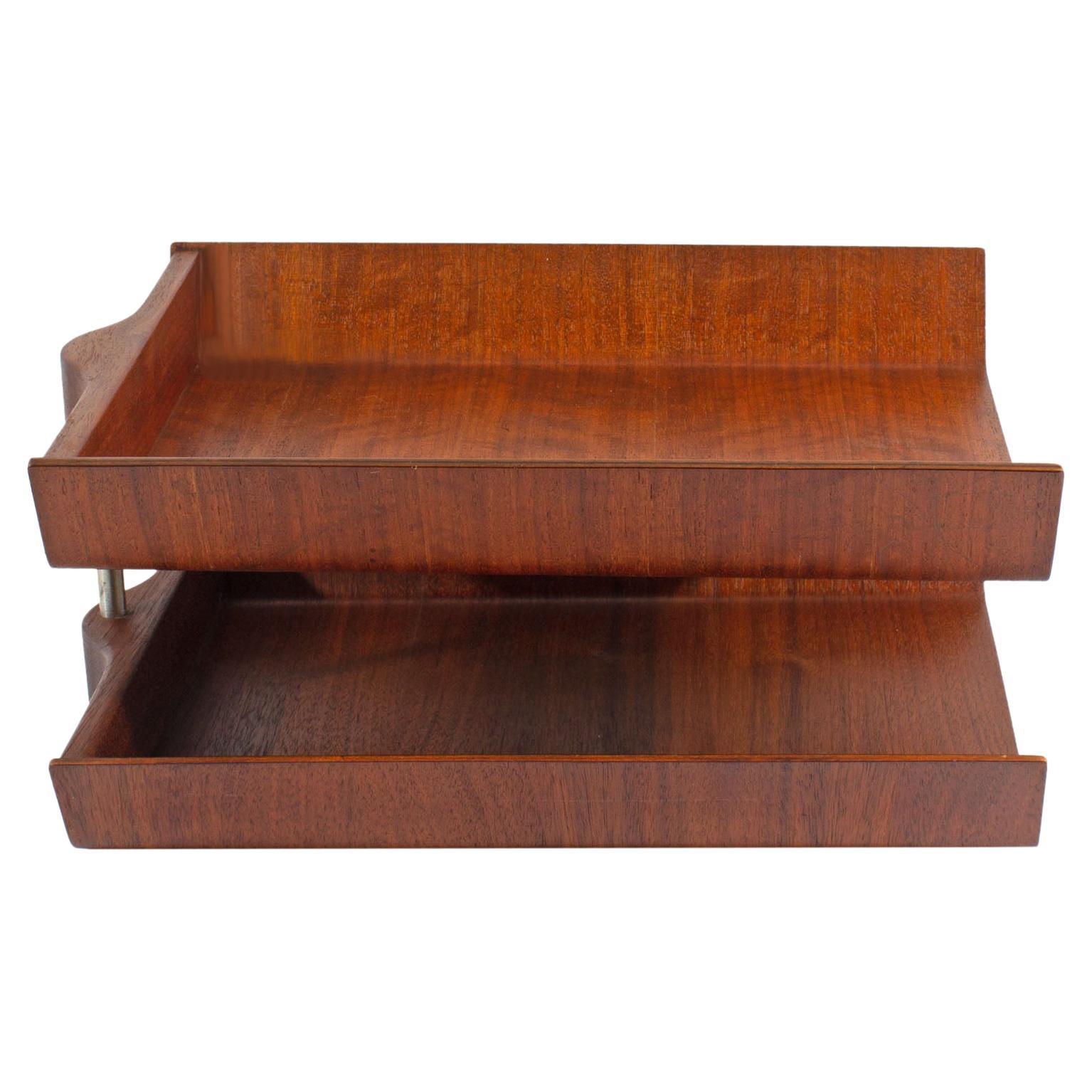 A molded plywood pivoting letter tray designed by American designer Florence Knoll (1917-2019) for Knoll International. Made between 1961-1970, two molded trays are adjoined by a metal dowel rod that allows the top tray to pivot. This iconic desk
