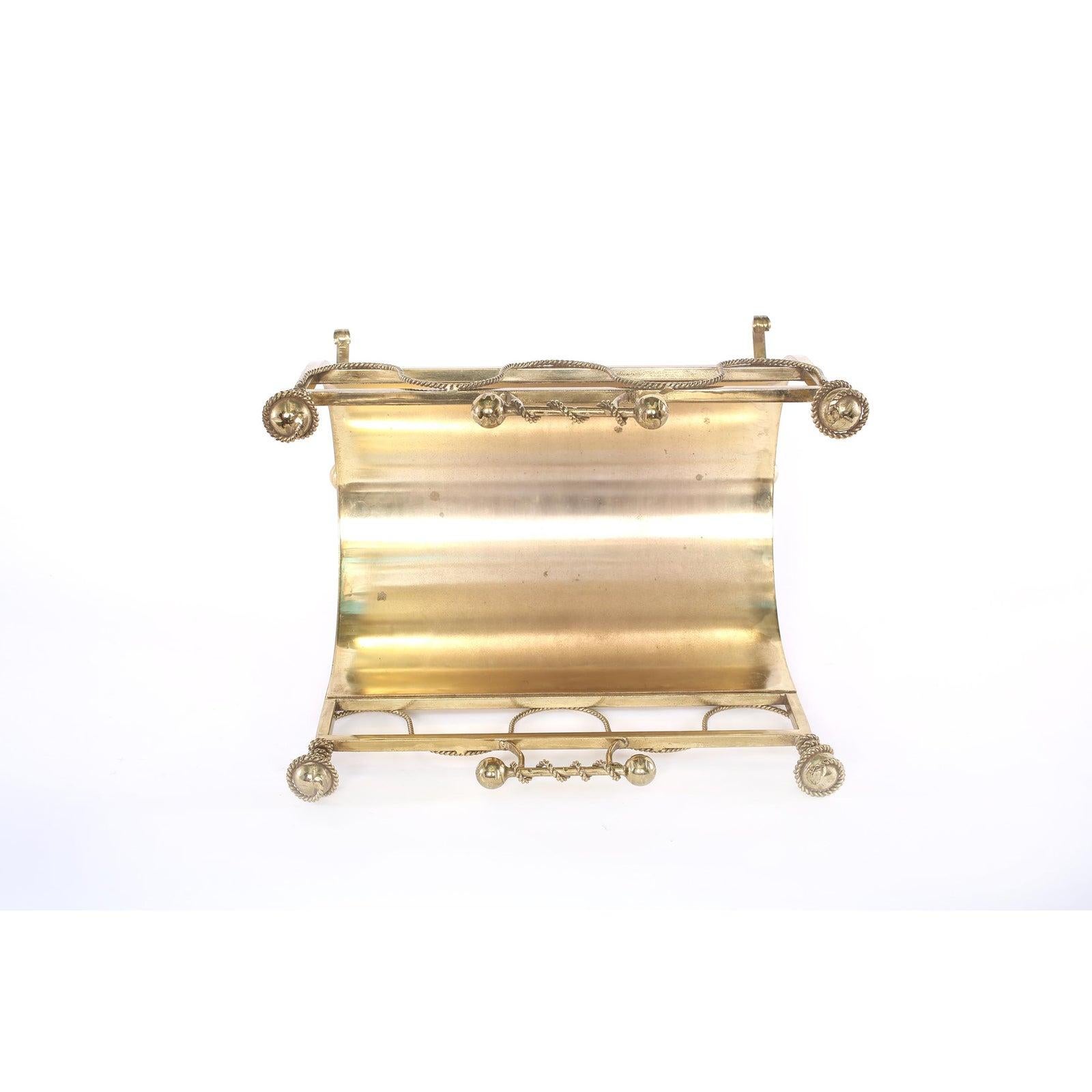Footed solid brass fire logs holder with top handles & exterior design details. The logs holder is very handsome and in great condition. Minor wear consistent with age / use. The piece stands about 17 inches high x 13 inches deep x 19 inches wide.