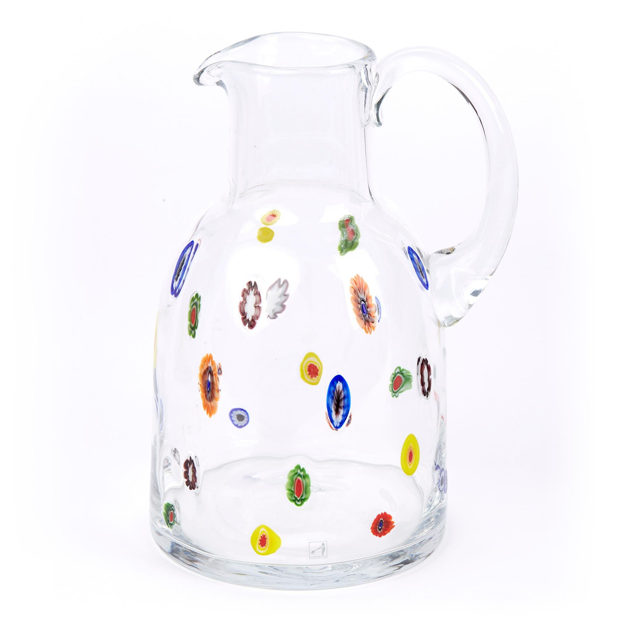 A large and impressive Italian Murano water jug in clear glass with randomly scattered colored murines within the body by Fratelli Toso. The bell shaped jug with a funnel top has a pouring handle to the neck with a wide base with a central polished