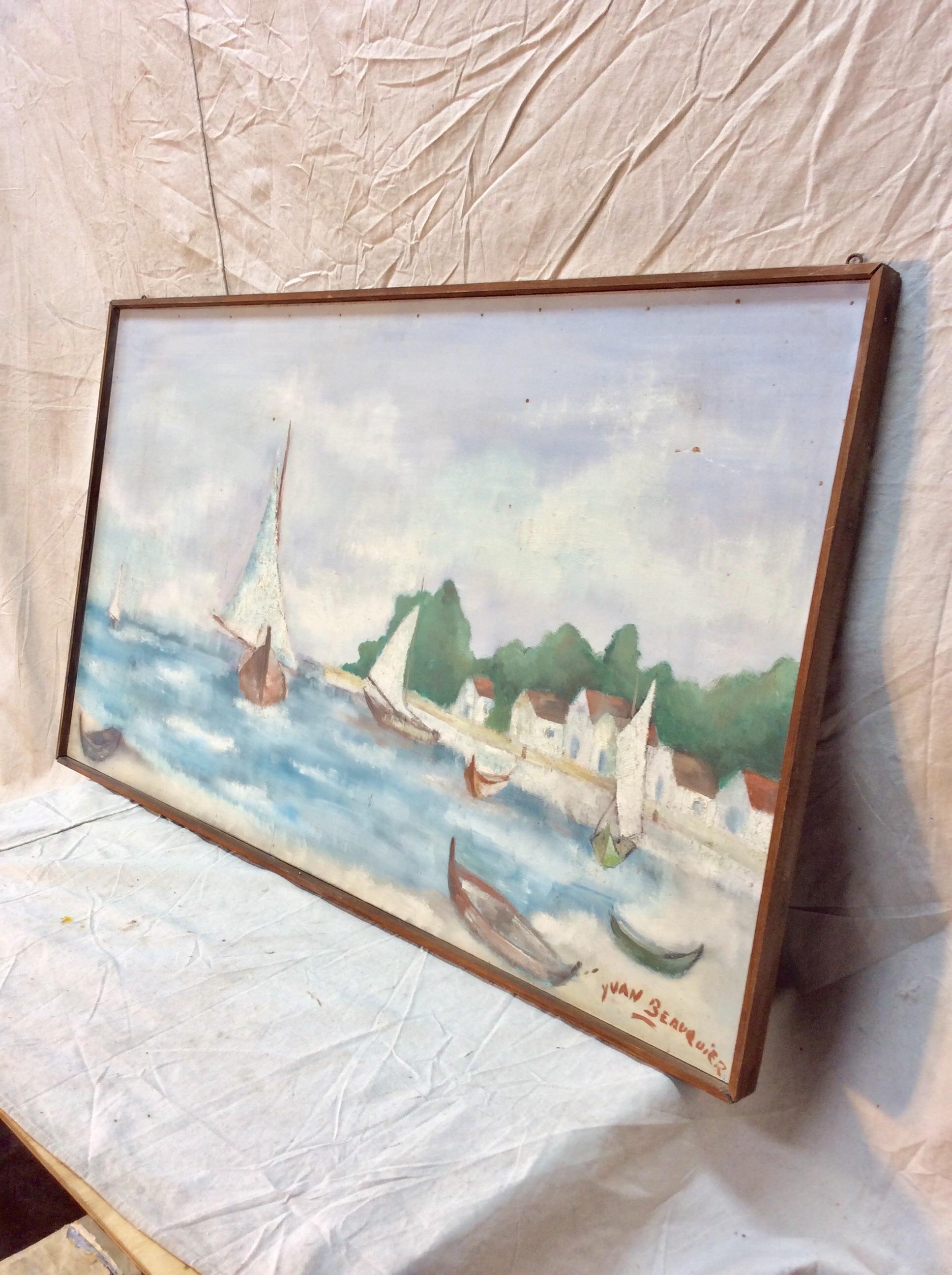 Found in the South of France this Mid-20th century French Artist Signed Framed Painting depicts boats on the water and beach of a small village. Signed by the artist, Yuan Beauquier, the painting was done on board and framed in a wood frame. This is