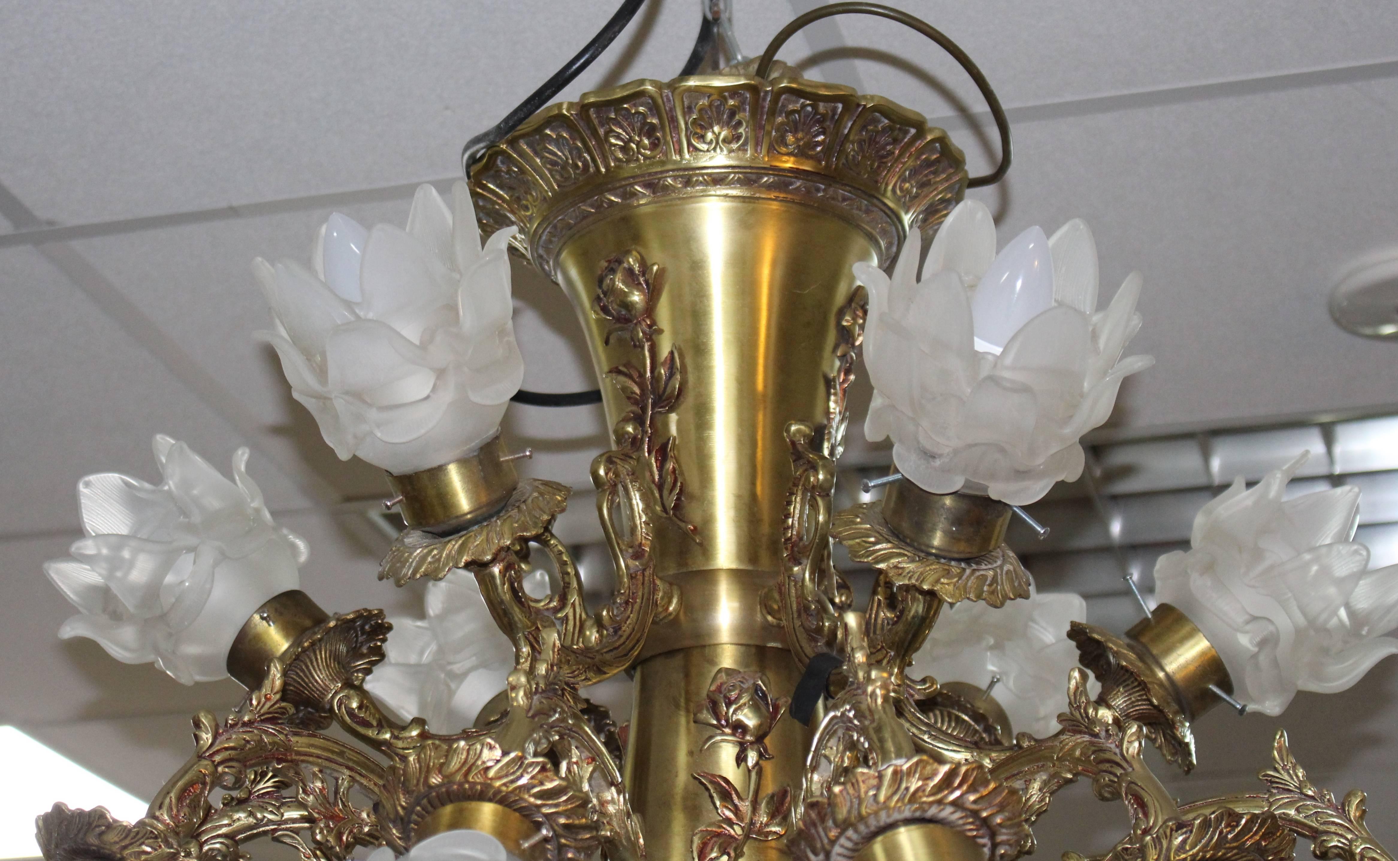 Period 
mid-20th century, circa 1950.

Composition 
brass frame with original glass flower formed shades

Measures: 
Width 84 cm, 33 inches
Drop (excluding rose and chain) 79 cm / 31 inches

Condition 
Offered in very good condition