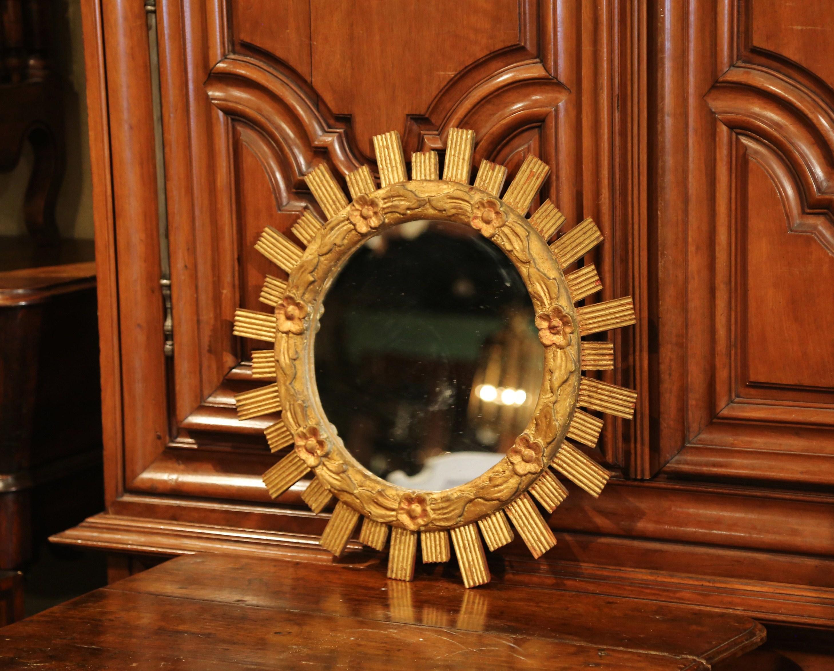 Patinated Mid-20th Century French Carved Giltwood Sunburst Mirror with Floral Decor