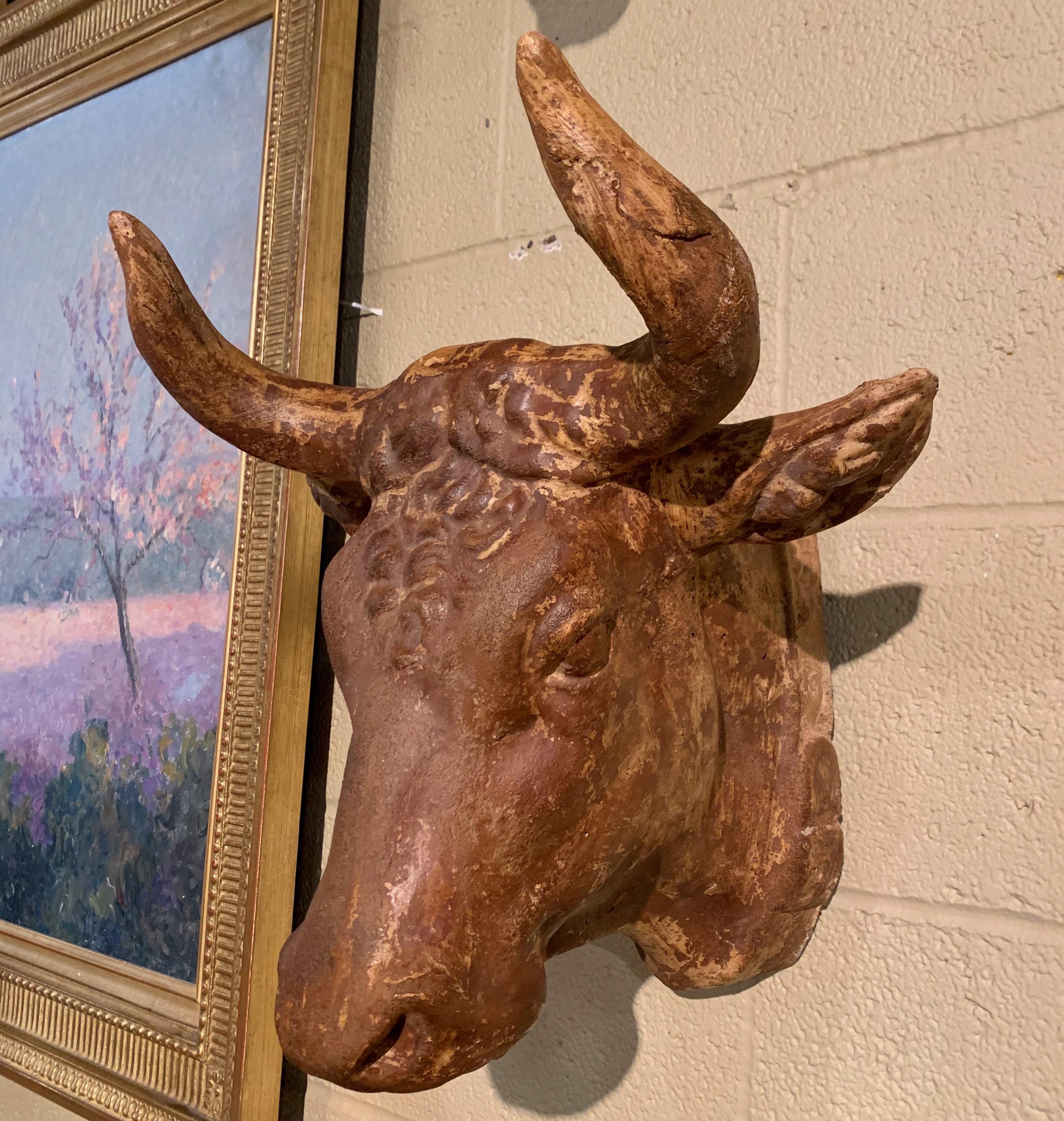 This beautiful antique cow head bust was crafted in France, circa 1950. Made of terracotta, the sculpture features a realistic cow head embellished with a collar in relief around the neck. The sculptural butcher sign is in excellent condition and