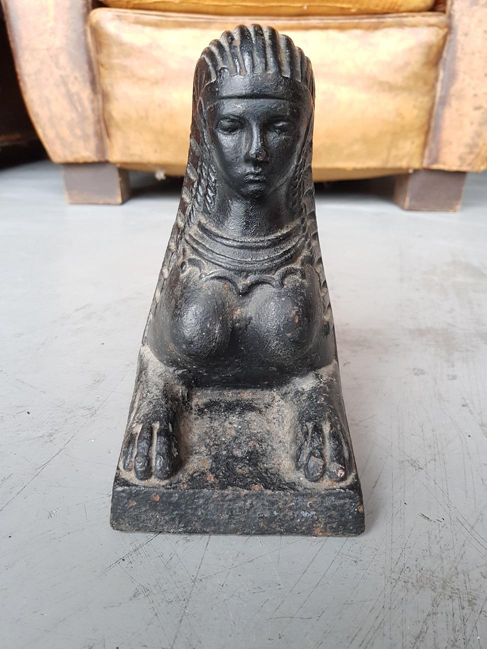 Set of vintage French cast chenets / fireplace bucks with an image of a Sphinx, mid-20th century.

The measurements are,
Depth 48.5 cm/ 19 inch.
Width 11 cm/ 4.3 inch.
Height 19 cm/ 7.4 inch.
 