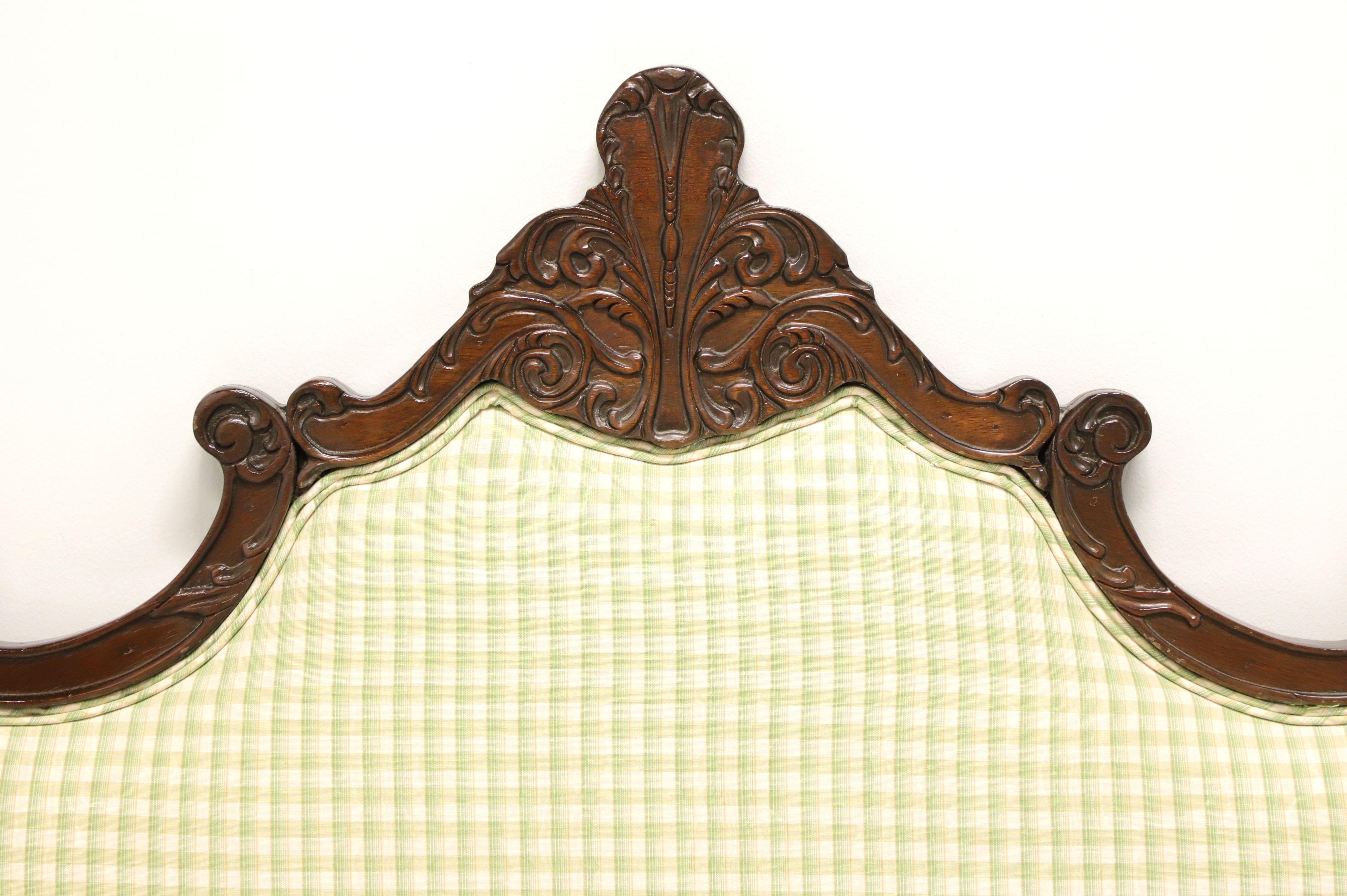 A French Country style king size upholstered headboard, unbranded, comparable quality to Drexel or similar. Decoratively carved arced walnut frame with soft mint green checked pattern upholstery. Made in the USA, in the mid 20th