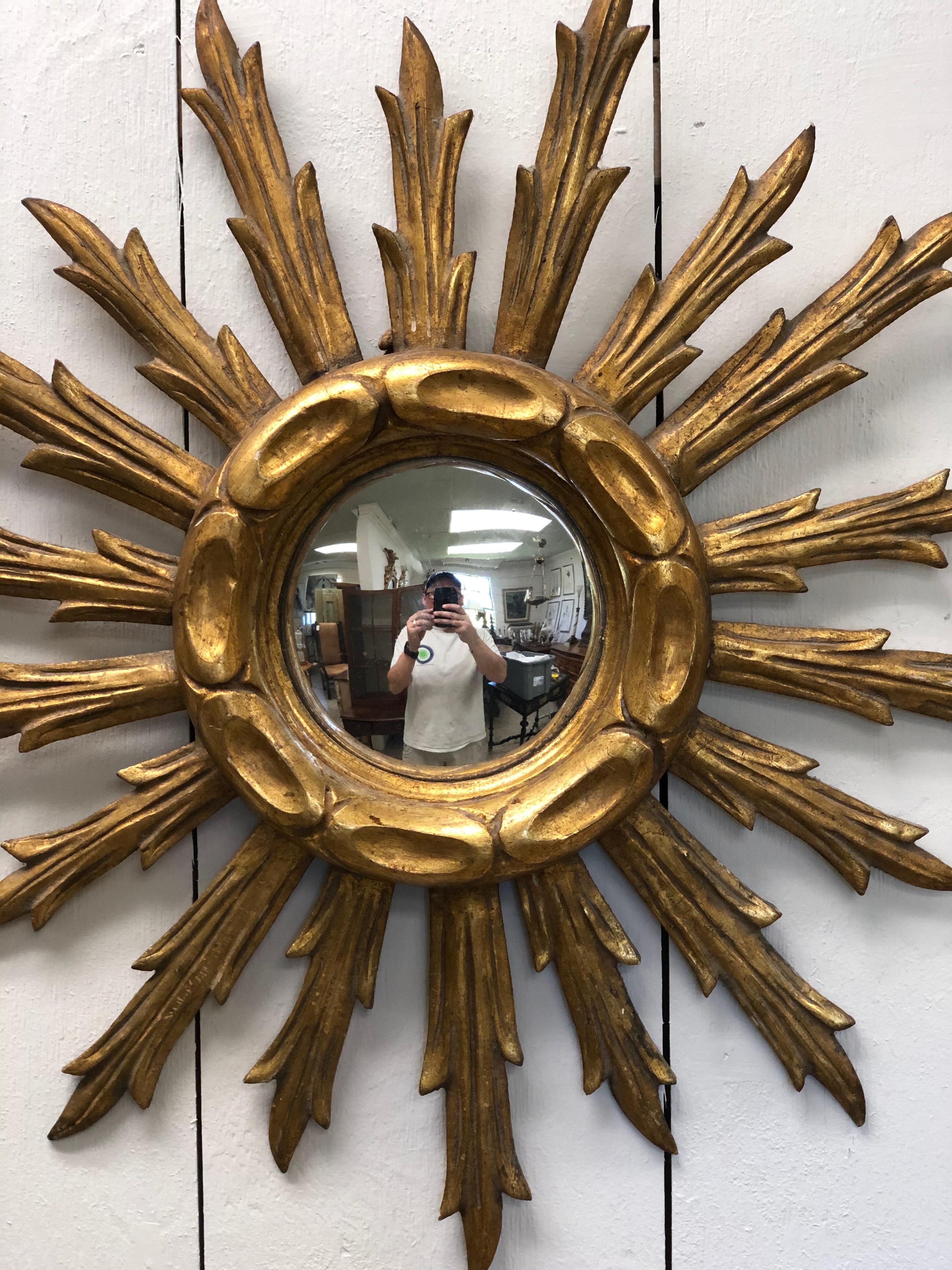 Beautiful French giltwood sunburst mirror with 18 rays and convex mirror.