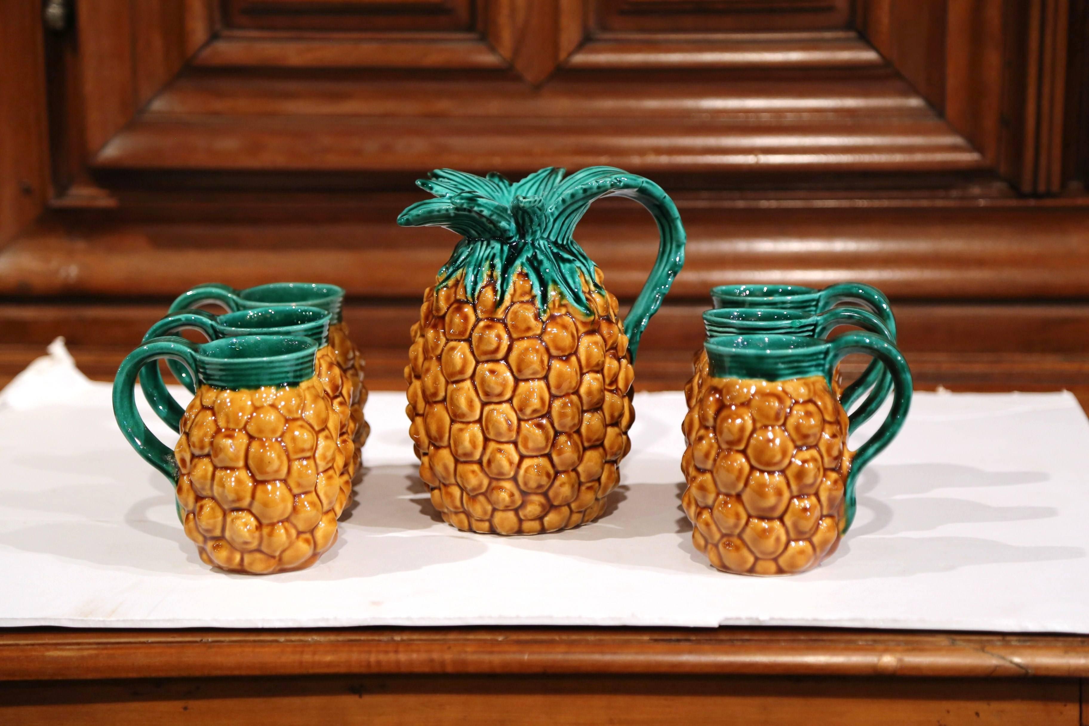 This novelty ceramic pineapple set from France is a must-have for summer! The sculptural, colorful, Majolica drinking set was crafted in the south of France, circa 1950. The playful barbotine set features six mugs with a handle and a matching
