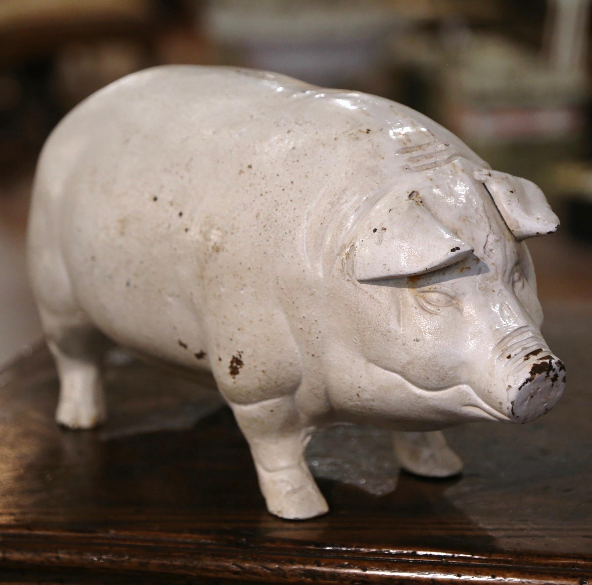Decorate a kitchen counter with this large vintage iron pig sculpture. Crafted in France, circa 1960, the hand painted pig is dressed with a slot for coins at the pediment and key under the belly; with very realistic shape and detail, the piggy bank