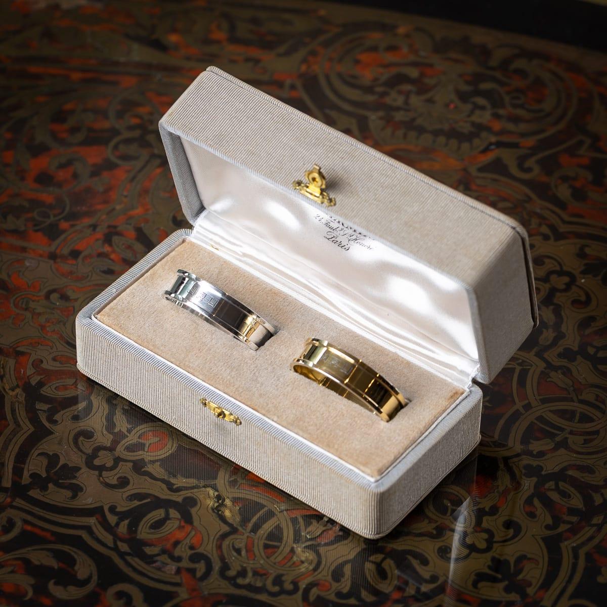 A stylish pair of mid 20th Century French solid silver-gilt Hermès napkin rings. One crafted in gilt silver and the other in plain silver, each of circular form with simple borders. Housed in their original fitted case.

One stamped 